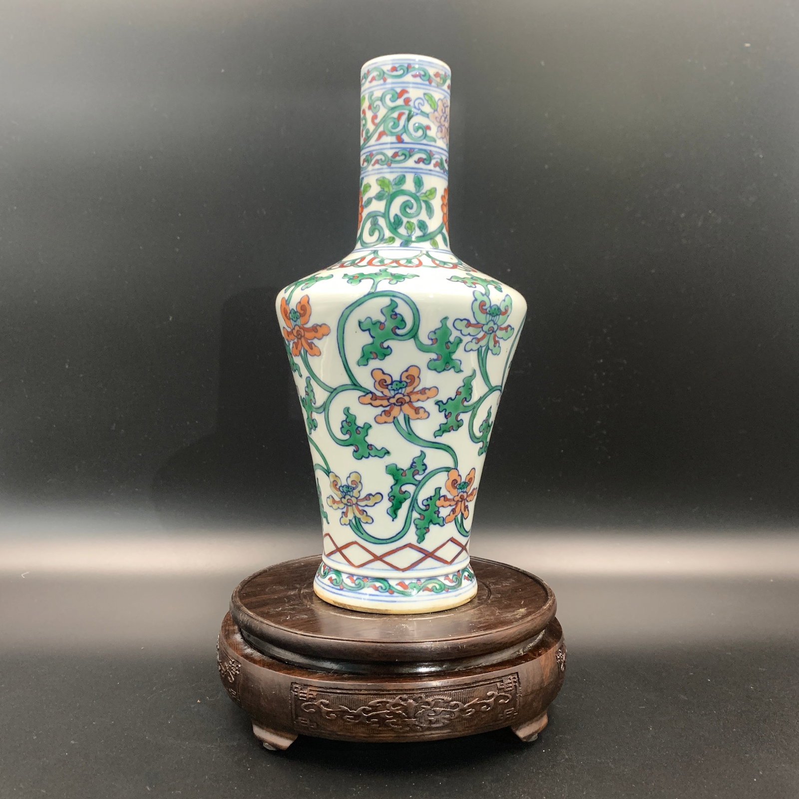 DOUCAI STYLE "FLORAL AND VINE" PORCELAIN VASE: Qing Dynasty; High: 9.9 inch; Diameter: 4.7 inch. Wooden base for picture and display only.
