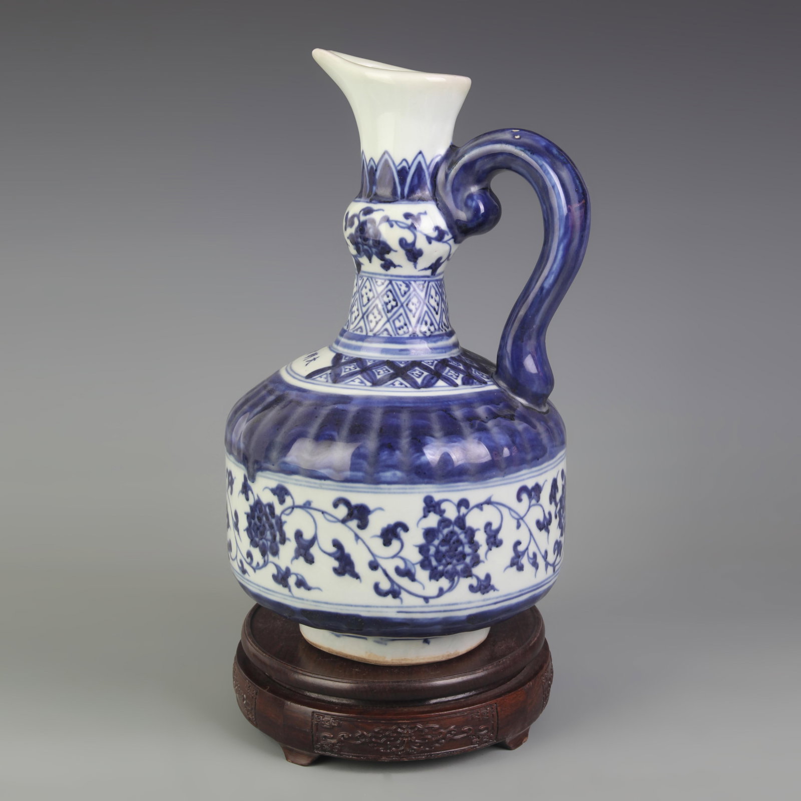 BLUE AND WHITE PORCELAIN TEAPOT WITH LOTUS PATTERN: Ming Dynasty Style; High: 11.6 inch; Diameter: 6.5 inch. Wooden base for picture and display only.