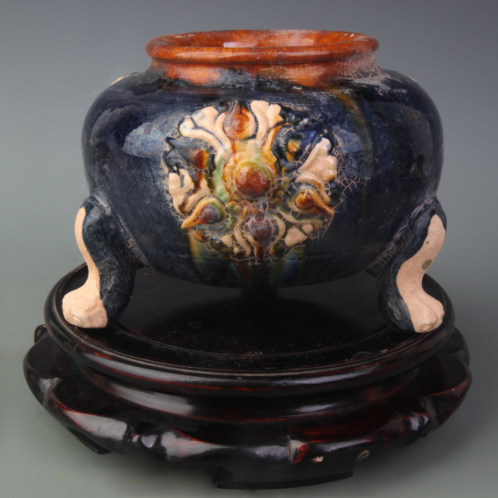A SANCAI TRIPOD JAR WITH APPLIQUÉ DECORATION: Tang Dynasty Style; Diameter: 4.9 inch; High: 5.5 inch; Wooden base for picture and display only.