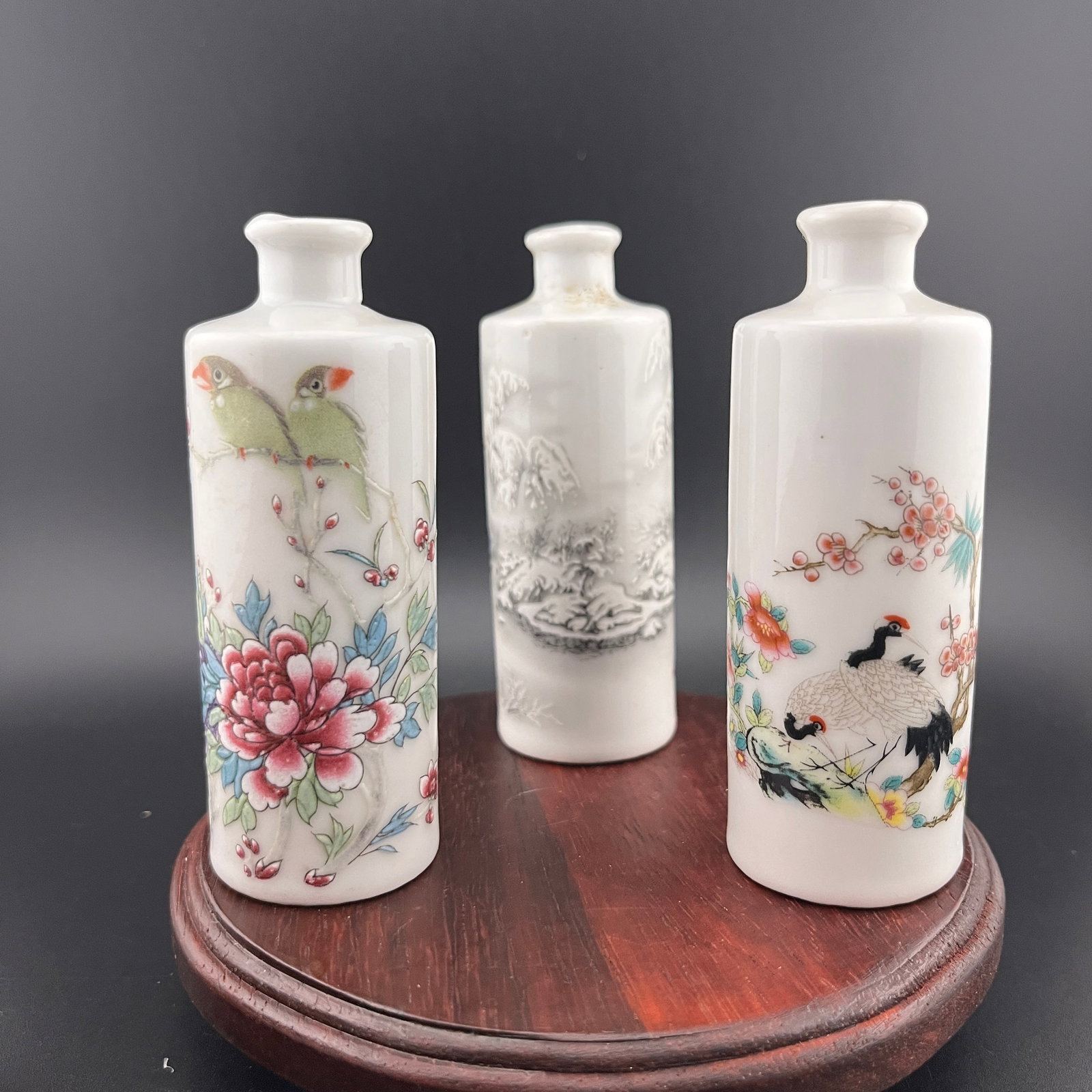 GROUP OF THREE FAMILLE ROSE PORCELAIN SNUFF BOTTLE: Modern; High: 3.8 inch; Diameter: 1.4 inch. Wooden base for picture and display only.
