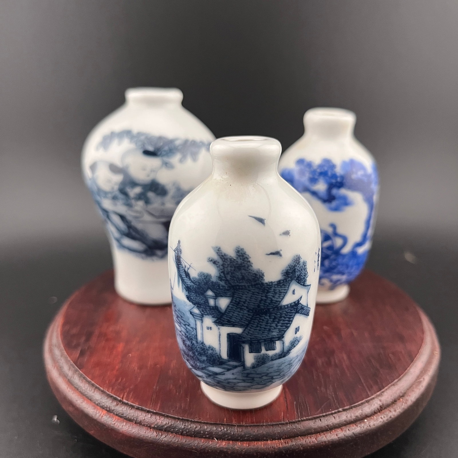GROUP OF THREE FAMILLE ROSE PORCELAIN SNUFF BOTTLE: Modern; High: 2.6 inch; Diameter: 1.42 inch; High: 2.6 inch; Diameter: 1.42 inch; High: 2.88 inch; Diameter: 1.88 inch. Wooden base for picture and display only.