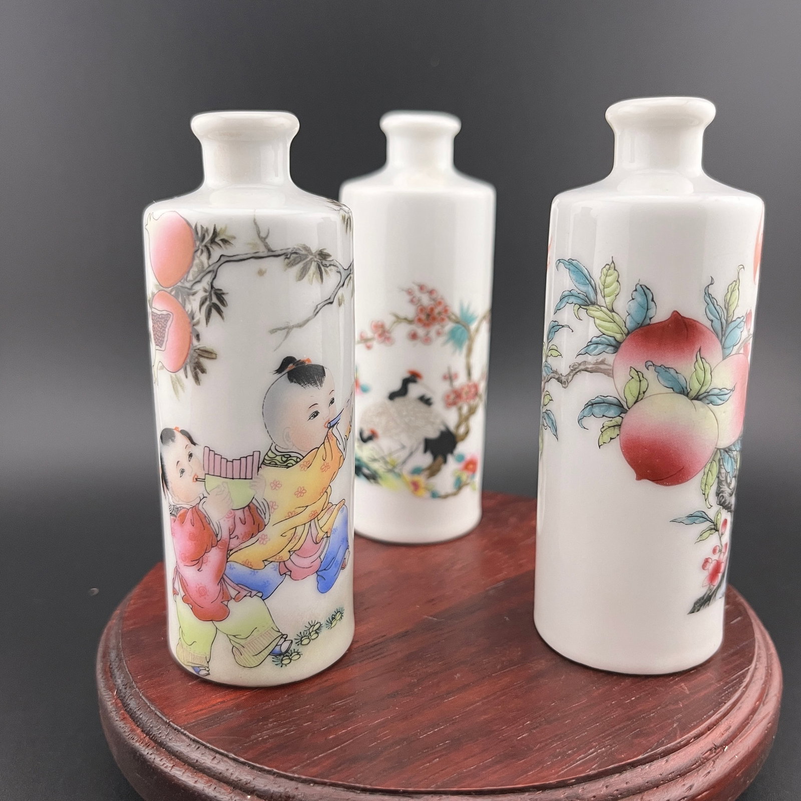 GROUP OF THREE FAMILLE ROSE PORCELAIN SNUFF BOTTLE: Modern; High: 3.69 inch; Diameter: 1.35 inch; High: 3.73 inch; Diameter: 1.39 inch; High: 3.8 inch; Diameter: 1.39 inch. Wooden base for picture and display only.