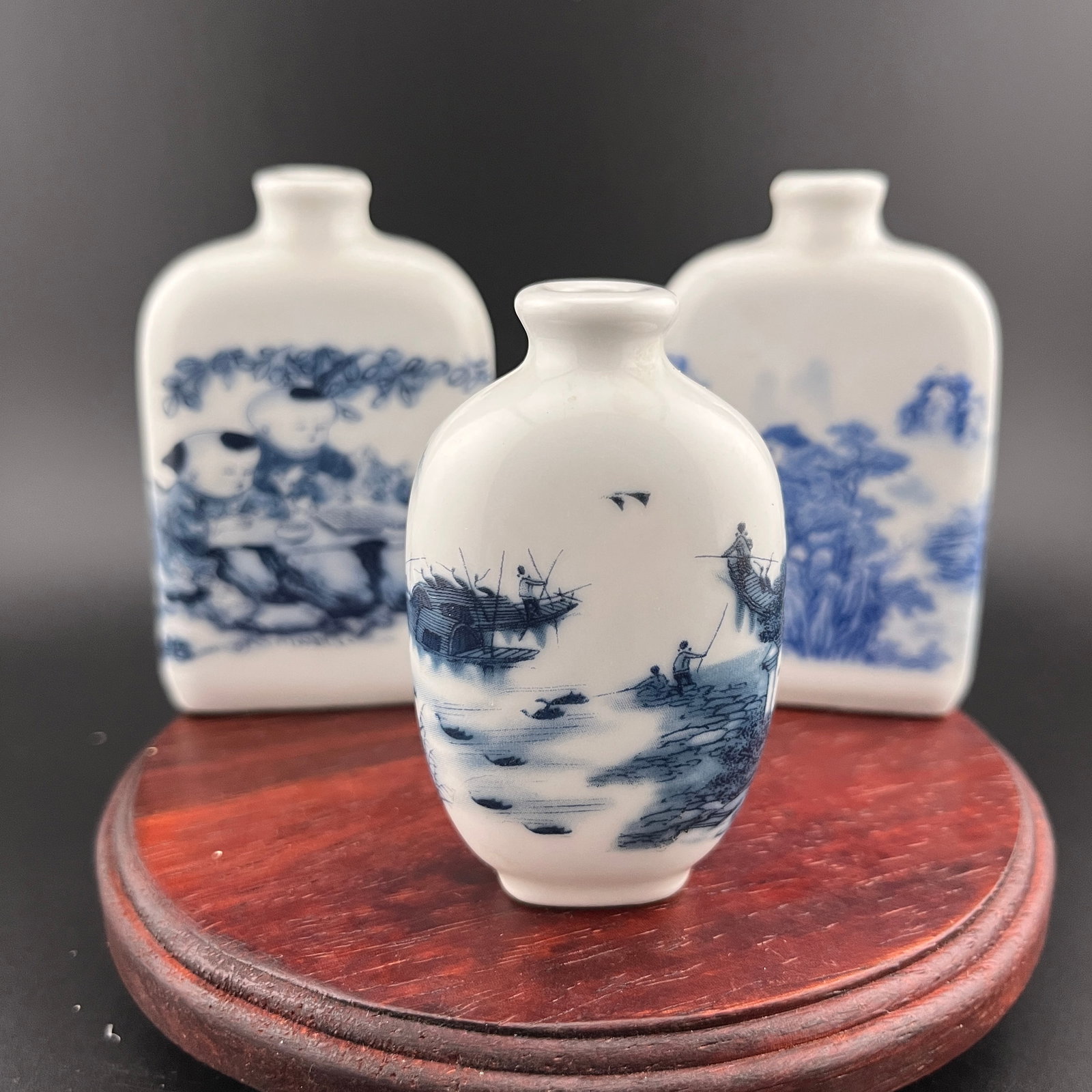 GROUP OF THREE FAMILLE ROSE PORCELAIN SNUFF BOTTLE: Modern; Long: 2.1 inch; Width: 0.87 inch; High: 3.1 inch; Long: 2.1 inch; Width: 0.87 inch; High: 3.1 inch; Long: 1.65 inch; Width: 1.1 inch; High: 2.74 inch. Wooden base for picture and display only.