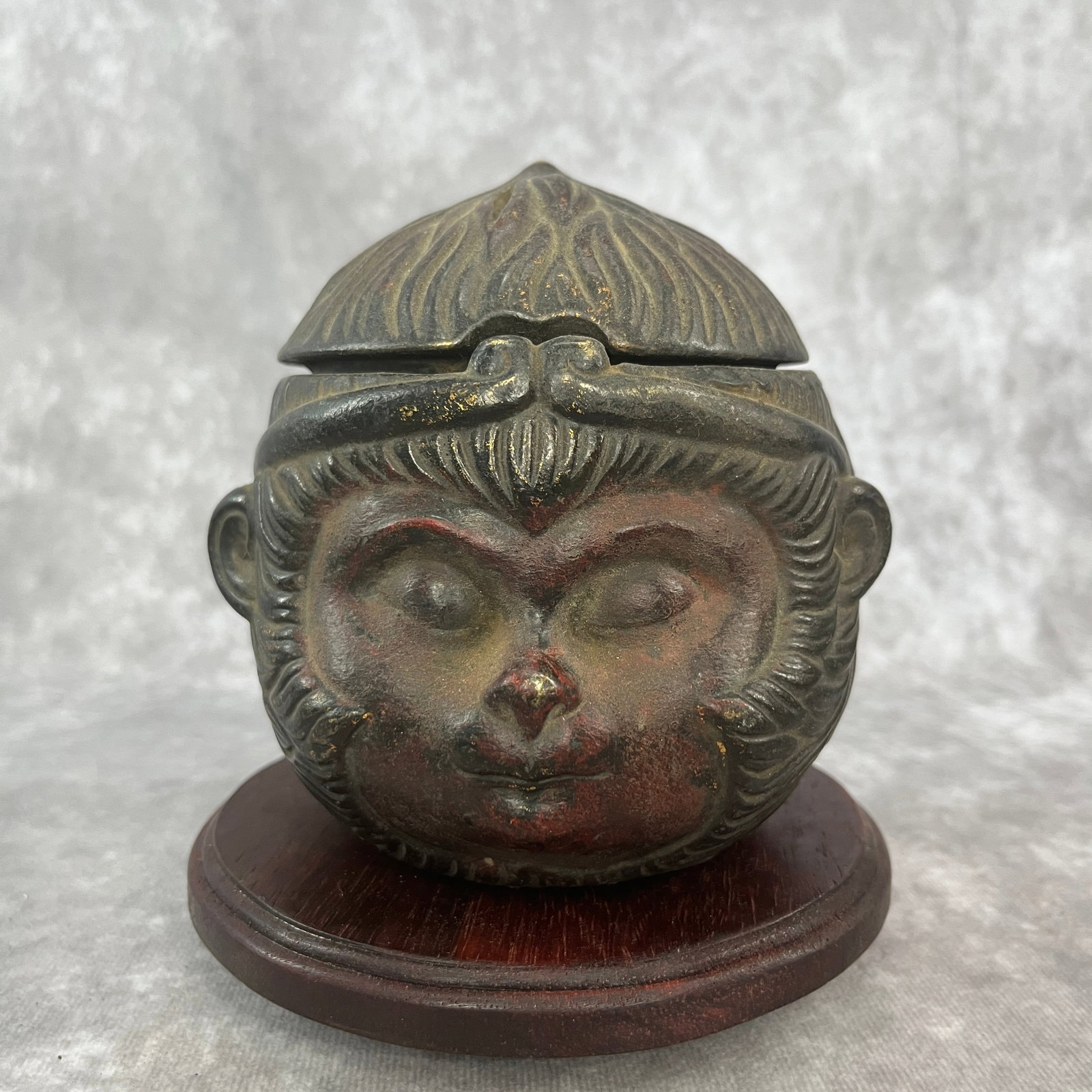A FINE BRONZE MONKEY HEAD STYLE BRONZE INCENSE BURNER: Qing Dynasty; High: 4.8 inch; Diameter: 4.6 inch. Wooden base for picture and display only.
