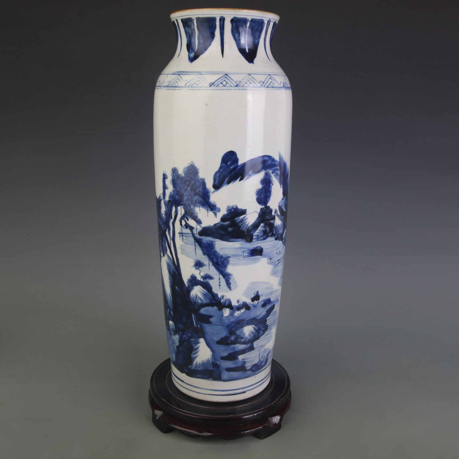 A BLUE AND WHITE CYLINDRICAL VASE WITH LANDSCAPE DECORATION: Qing Dynasty; Diameter: 4.5 inch; High: 16.6 inch; Wooden base for picture and display only.