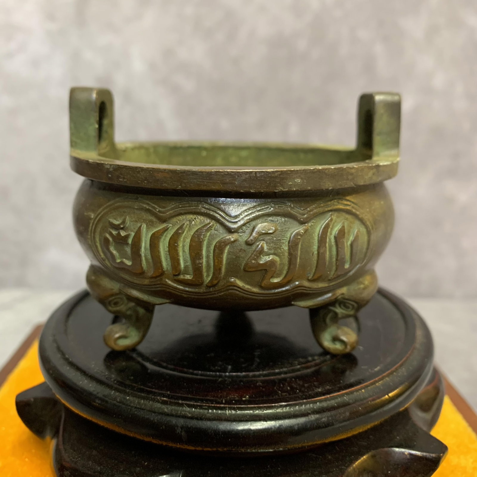 A FINE SANSKRIT-INSCRIBED THREE-LEGGED ROUND BRONZE CENSER: 19th Century; High: 3.4 inch; Width: 3.0 inch; Diameter: 3.0 inch; Wooden base for picture and display only.