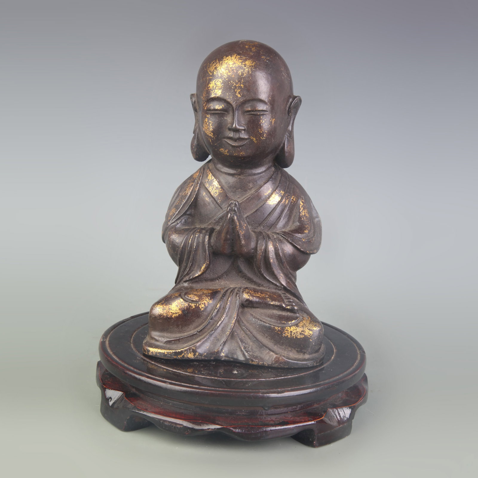 GILT-BRONZE FIGURE OF A SEATED BUDDHIST MONK: Qing Dynasty; High: 7.4inch; Woodbase for picture and display only