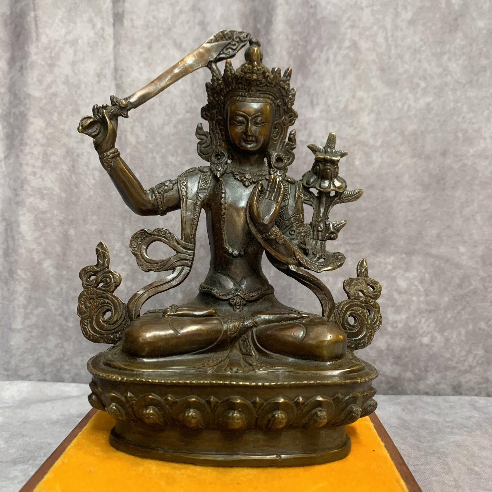 A FINE BRONZE MANJUSHRI BODHISATTVA STATUE: Qing Dynasty; High: 8.0 inch; Width: 6.1 inch; Long: 3.4 inch; Woodbase for picture and display only