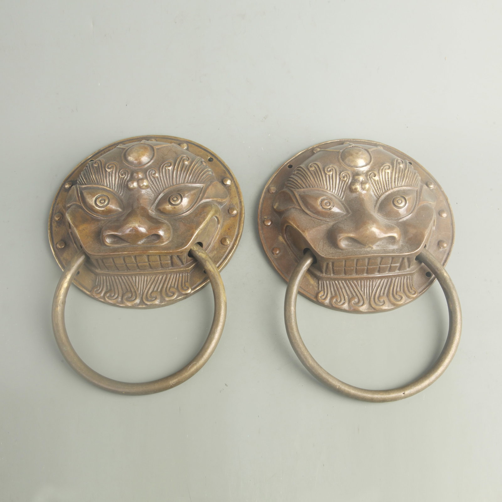 PAIR OF CHINESE BRASS OR BRONZE LION-HEAD DOOR KNOCKERS: Qing Dynasty; Long:7.80 inch; Woodbase for picture and display only