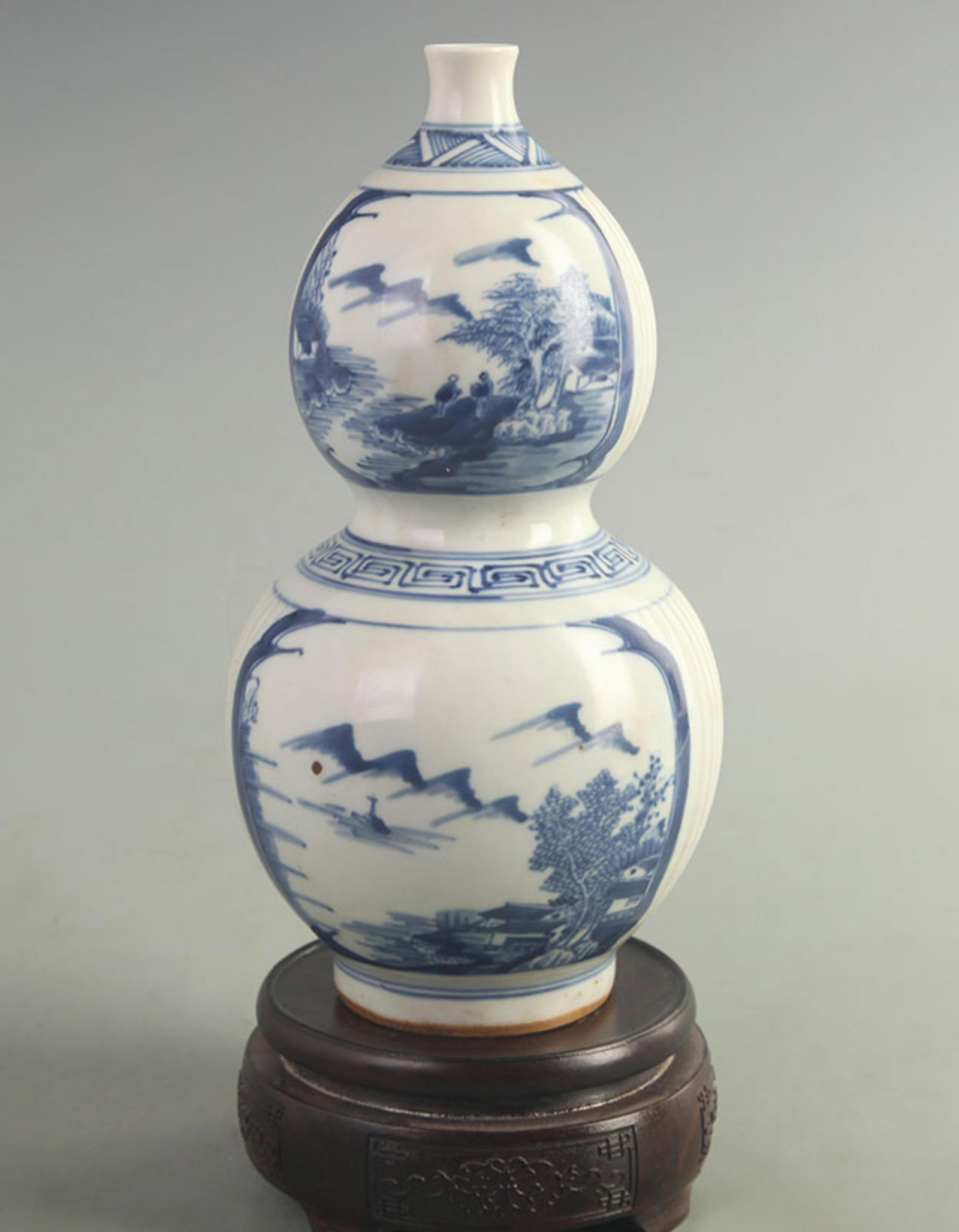 A FINE BLUE AND WHITE LANDSCAPE PATTERN PORCELAIN GOURD VASE: Qing Dynasty Kang Xi Period; High: 9.50 inch; Width: 4.50 inch; Woodbase for picture and display only