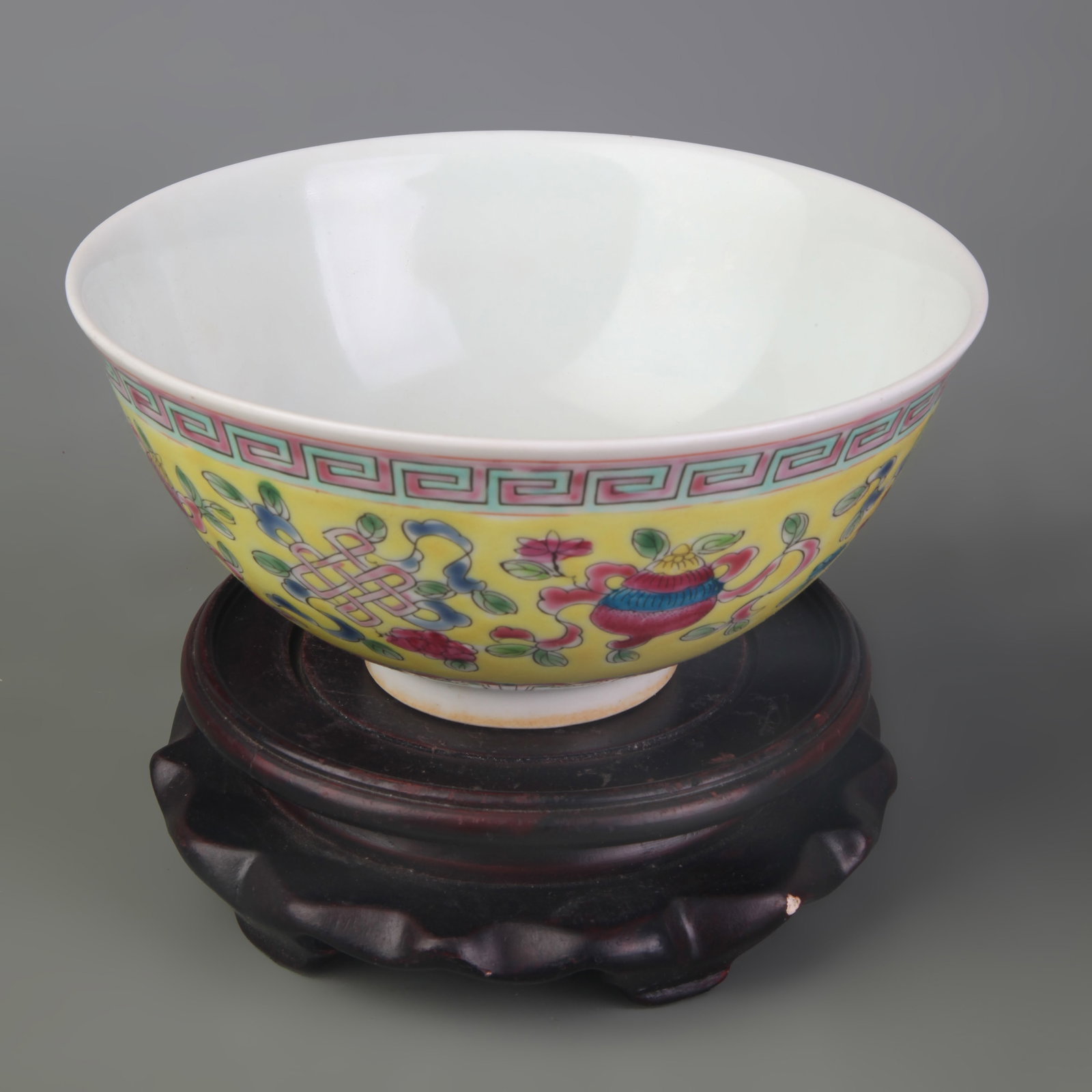 FAMILLE ROSE YELLOW-GROUND BOWL WITH EIGHT BUDDHIST EMBLEMS: Qing Dynasty Qian Long Period; Diameter: 5.9inch , High: 2.8inch; Woodbase for picture and display only