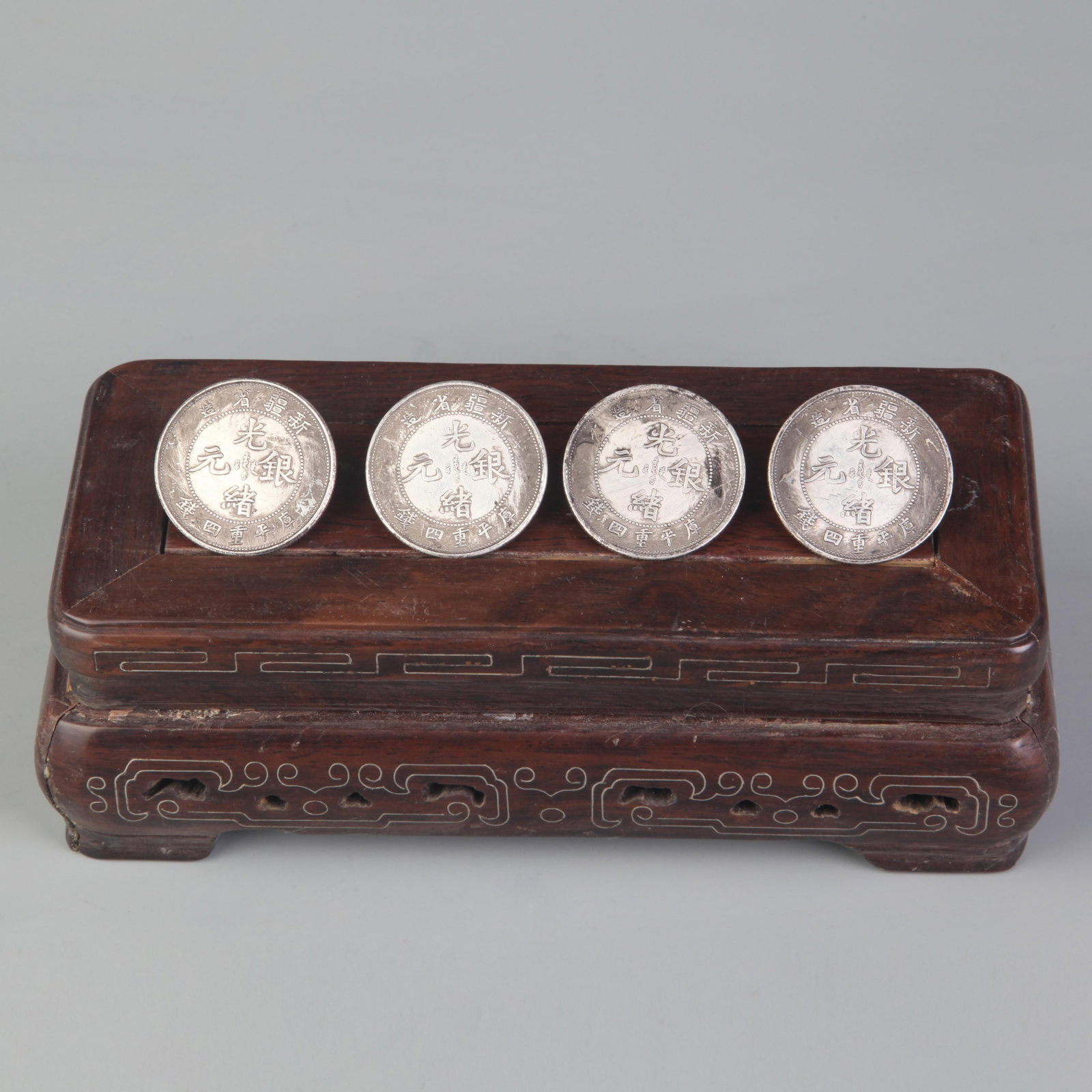 FOUR GUANGXU SILVER DRAGON COINS FROM XINJIANG PROVINCE: Republic Period, Diameter: 1.3; Woodbase for picture and display only