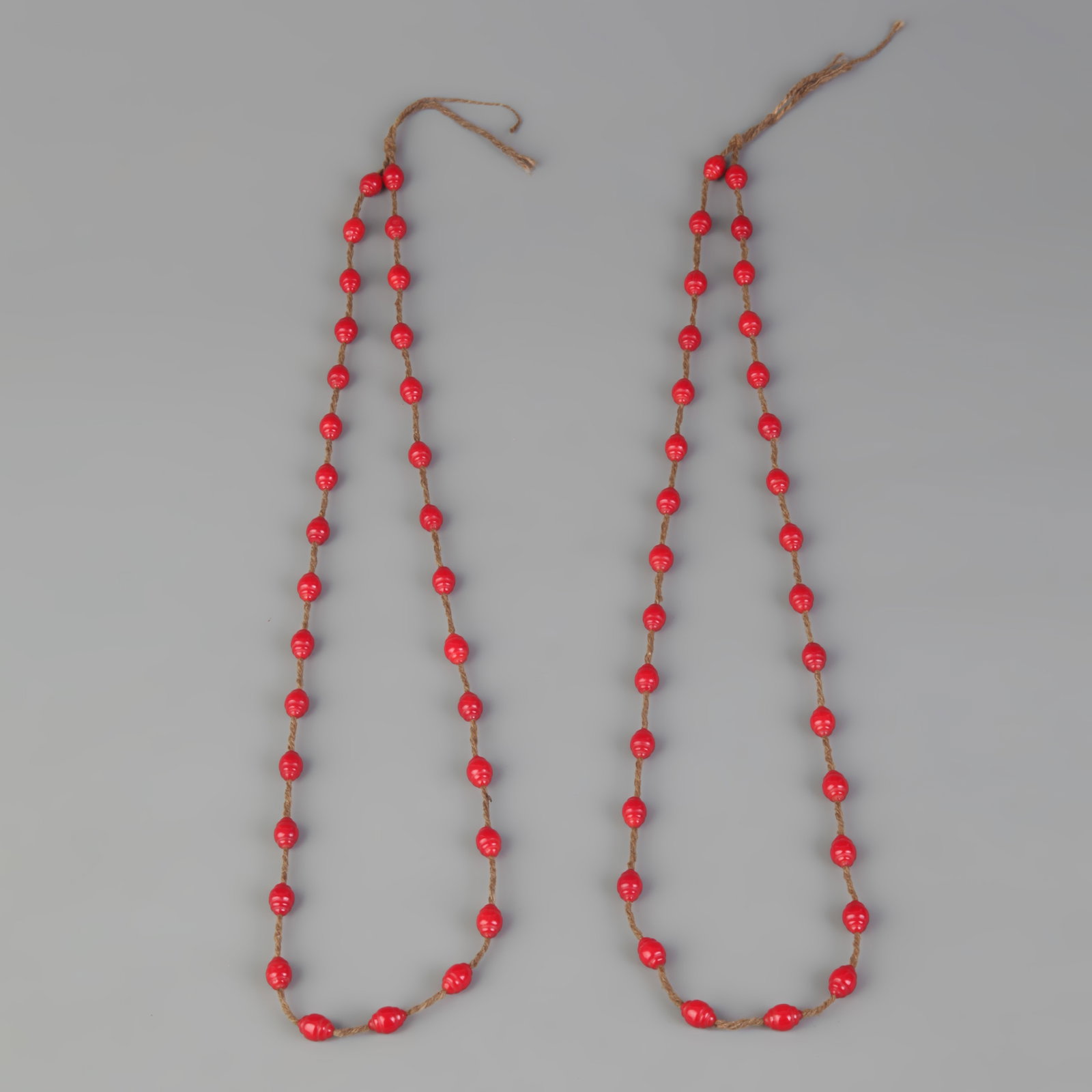 GROUP OF TWO RED CORAL NECKLACE: Modern, Long: 11.5 inch; Diameter: 0.2 inch; Woodbase for picture and display only