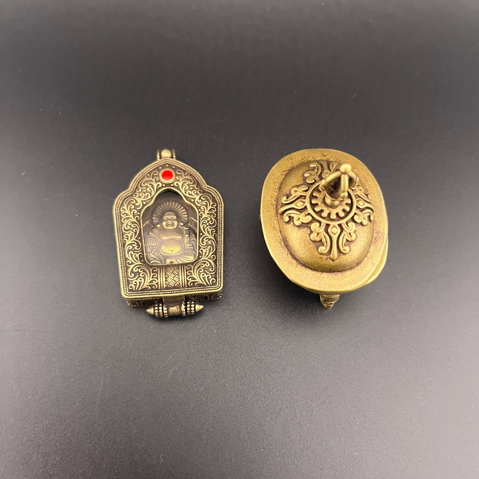 GROUP OF TWO TIBETAN PENDANTS SIPAHO PLAQUES: 20th Century; Long: 1.7 inch; Width: 1.3 inch; High: 1.9 inch; Long: 2.12 inch; Width: 1.28 inch; High: 0.4 inch; Woodbase for picture and display only