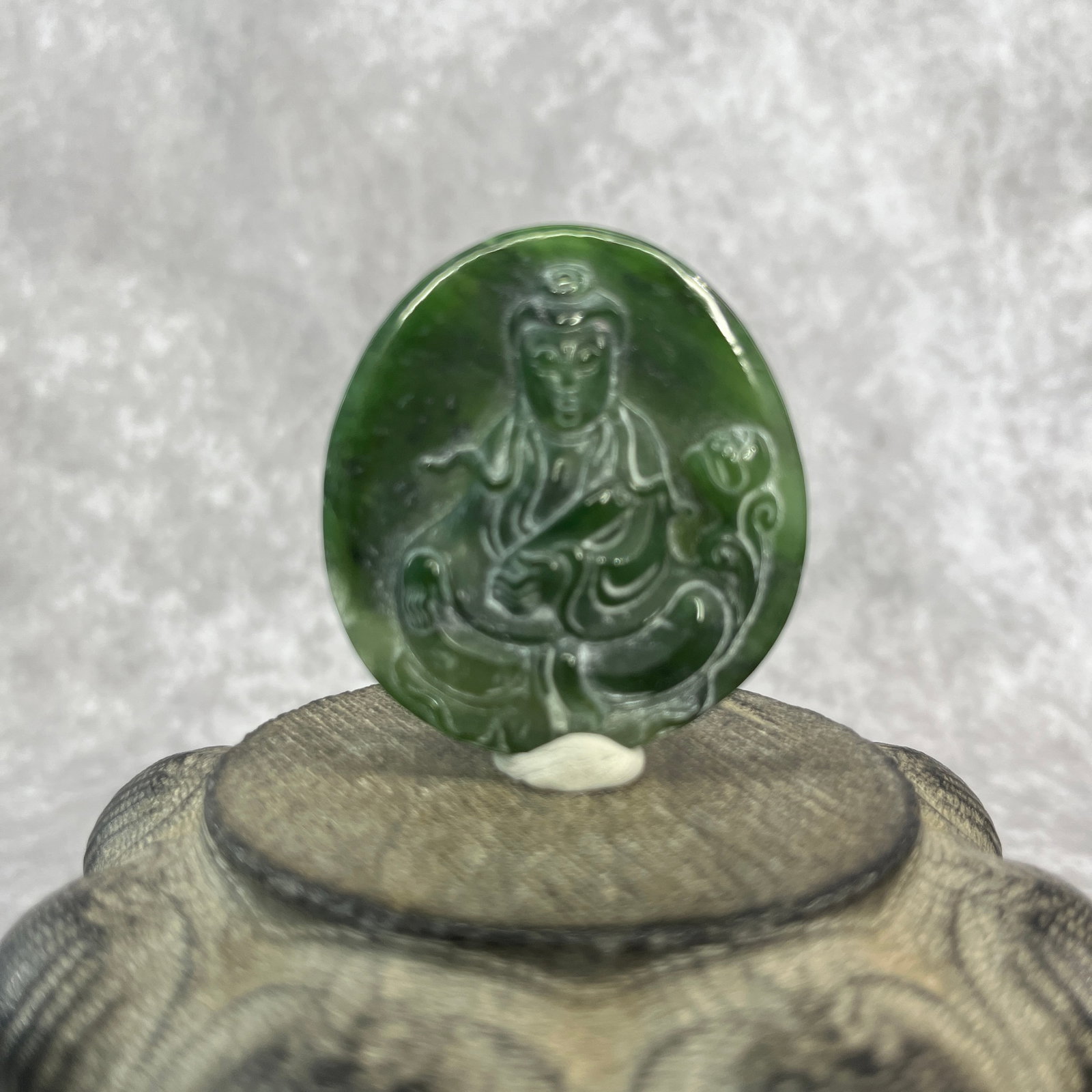 HAND-CARVED JADE AMULET PLAQUE OF GUANYIN: Qing Dynasty; Long: 2.1 inch; Width: 1.9 inch; High: 0.32 inch; Woodbase for picture and display only