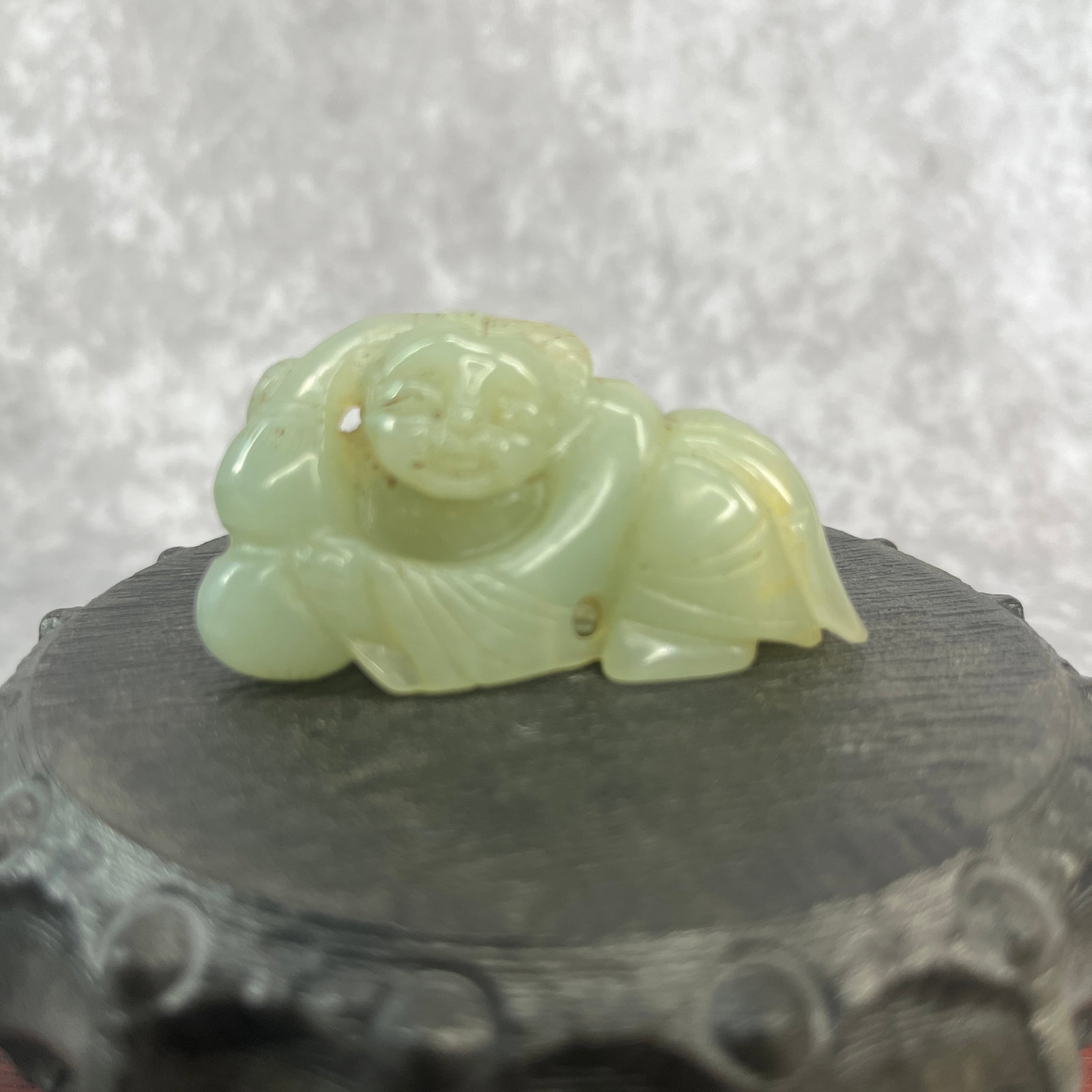 A FINE HETIAN JADE PENDANT IN FIGURE OF PLAYING BOY: Qing Dynasty; Long: 2 inch; Width: 1.2 inch; High: 0.8 inch; Woodbase for picture and display only