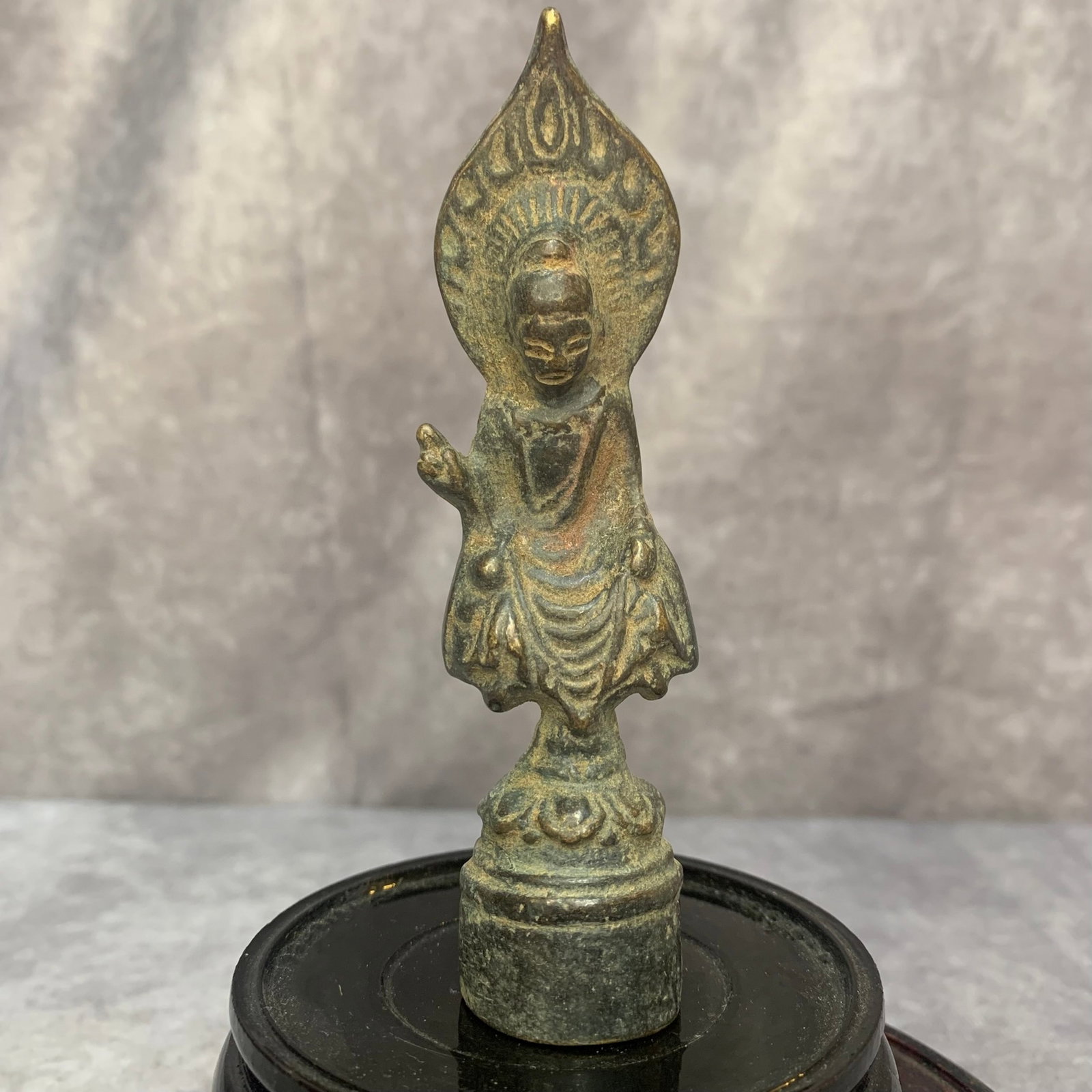 MINIATURE BRONZE VOTIVE FIGURE OF A SEATED BUDDHA: Qing Dynasty; High: 4.4 inch; Width: 1.2 inch; Woodbase for picture and display only