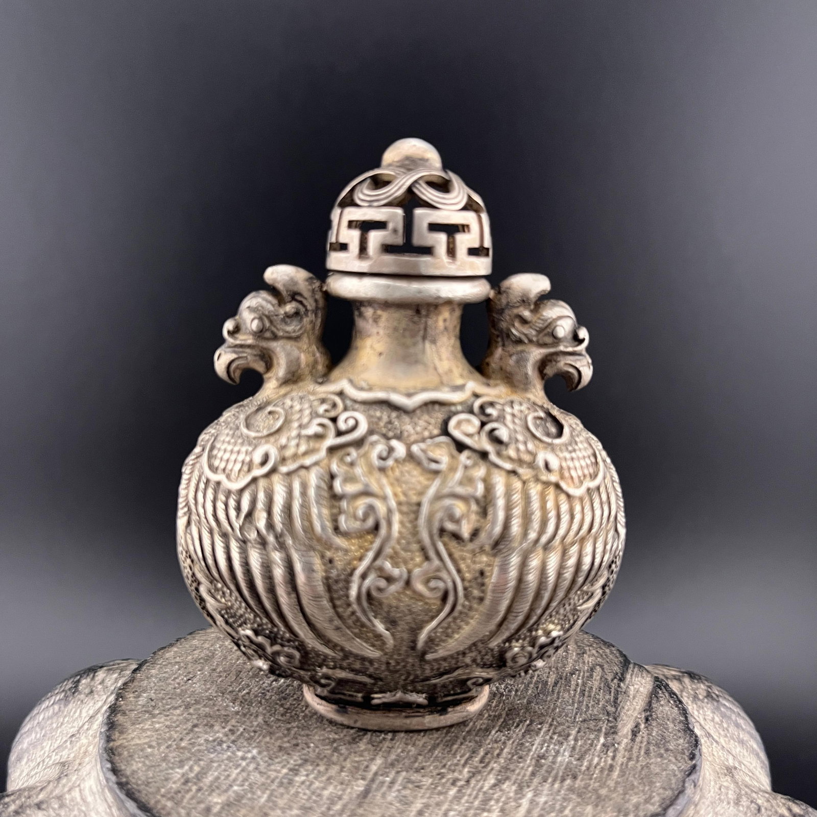 A FINELY CARVED WHITE BRONZE SNUFF BOTTLE: Qing Dynasty; Long: 2.08 inch; Width: 1.35 inch; High: 2.68 inch; Woodbase for picture and display only
