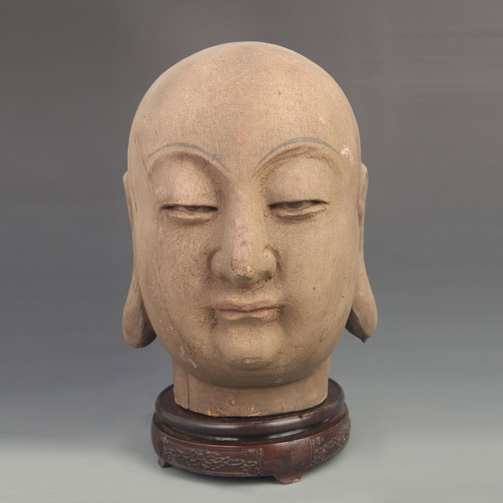 A WOODEN CARVED STATUE OF BODHISATTVA KSITIGARBHA'S HEAD: 18th Century; High: 11.25 inch; Width: 8.50 inch; Woodbase for picture and display only