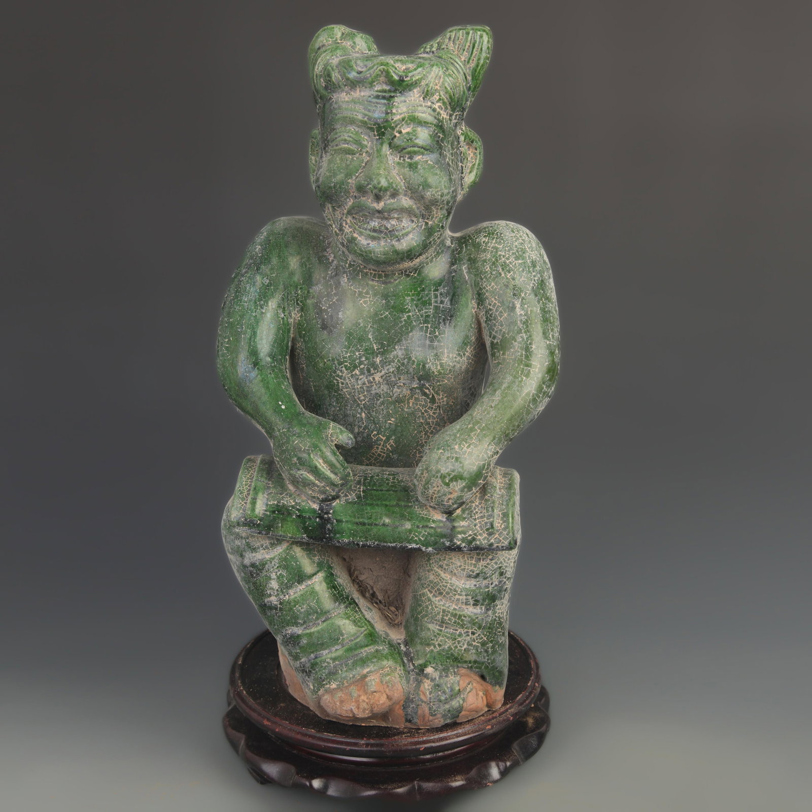 GREEN-GLAZED POTTERY FIGURE OF A SEATED MUSICIAN: Tang Dynasty Style; High: 14.75 inch; Width: 7.25 inch; Woodbase for picture and display only