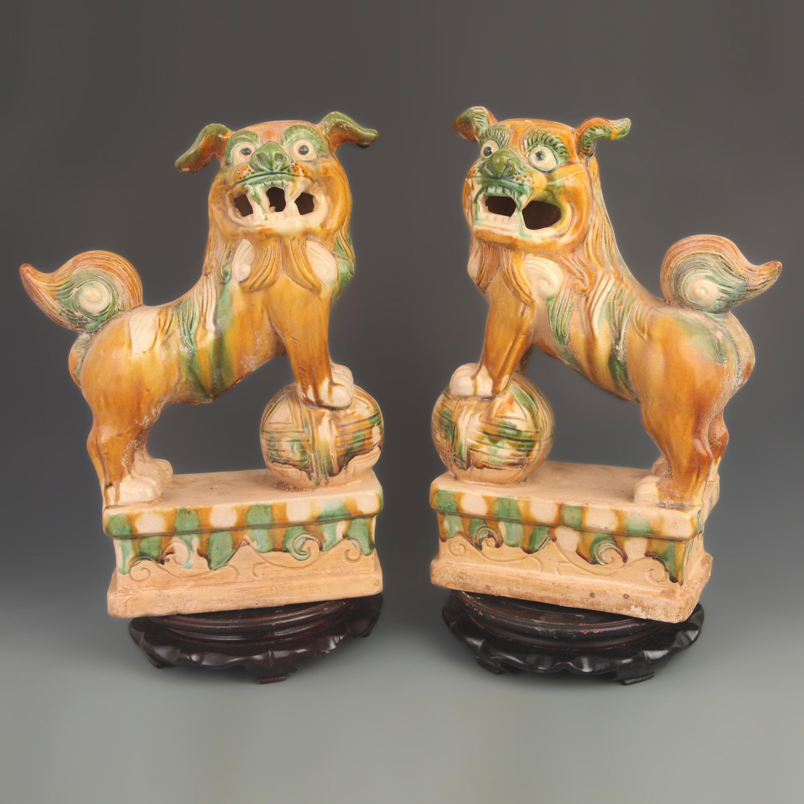 PAIR OF SANCAI-GLAZED GUARDIAN LIONS, MING DYNASTY OR LATER: Tang Dynasty Style; High: 15.5 inch; Width: 8.00 inch; Woodbase for picture and display only