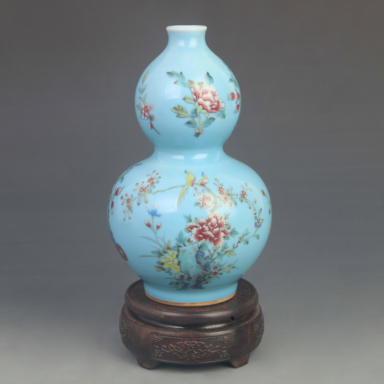 FAMILLE ROSE BLUE GROUND FLORAL GOURD VASE: Qing Dynasty Qian Long Period; High: 8.50 inch; Diameter: 4.80 inch; Woodbase for picture and display only