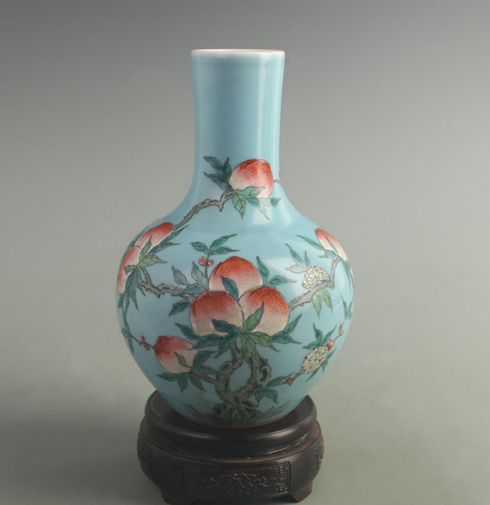BLUE-GROUND FAMILLE ROSE GLOBULAR VASE WITH NINE PEACHES: Qing Dynasty Qian Long Period; High: 9.00 inch; Width: 5.50 inch; Woodbase for picture and display only