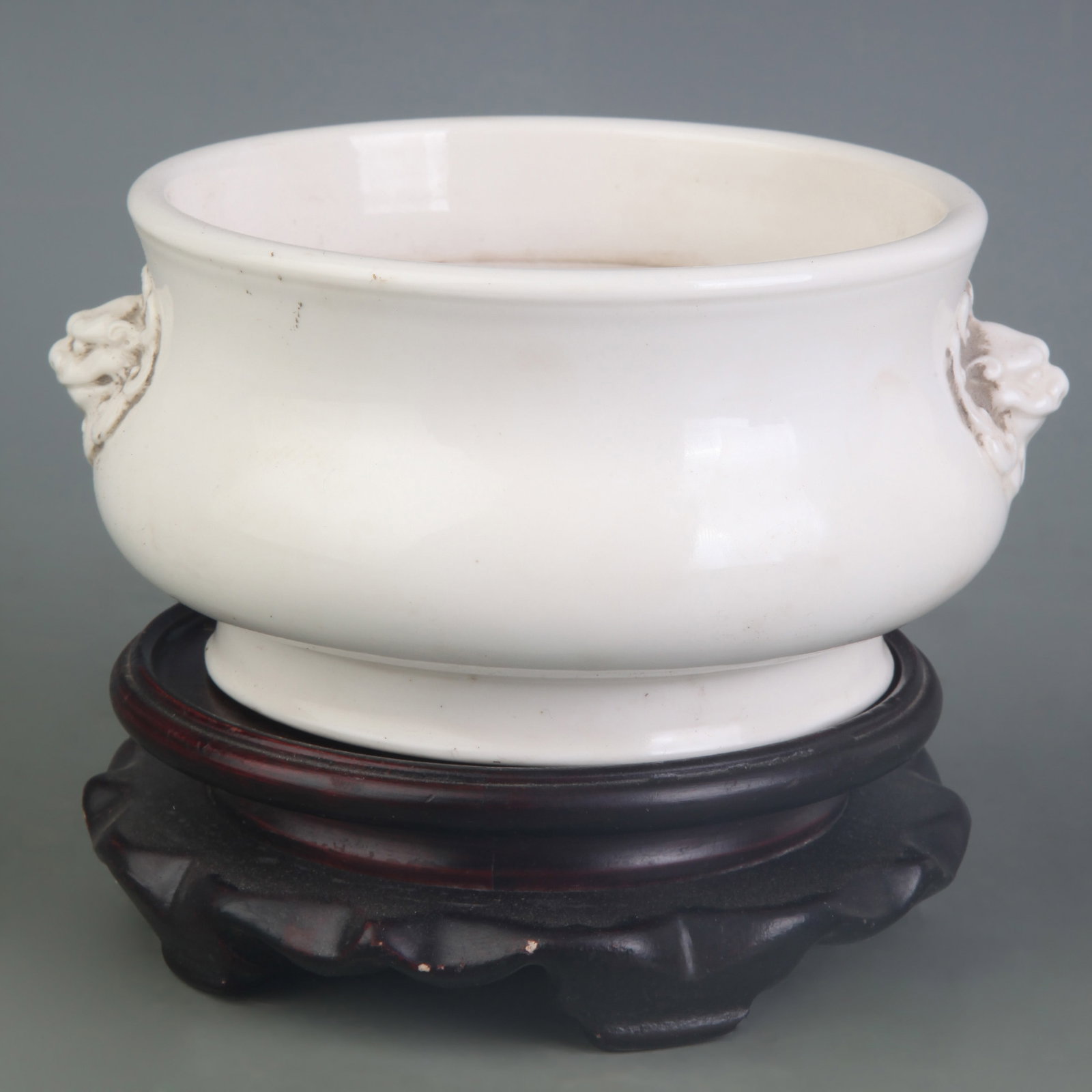 DEHU WHITE PORCELAIN CENSER WITH BEAST-HEAD HANDLES: Qing Dynasty; Diameter: 4.9inch , High: 2.8inch; Woodbase for picture and display only