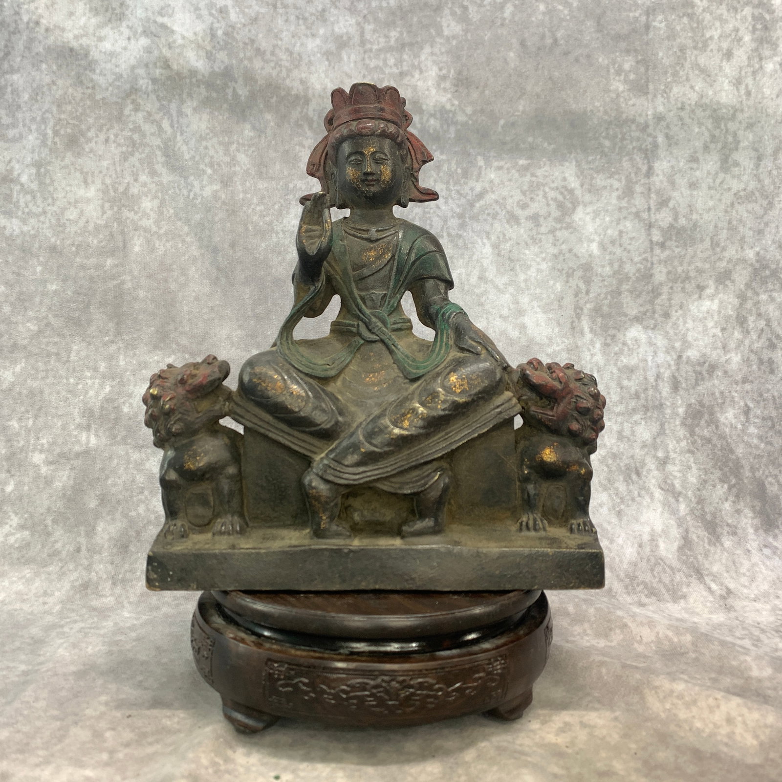 TIBETAN GILT-BRONZE FIGURE OF A BODHISATTVA FLANKED BY GUARDIAN LIONS: Qing Dynasty; Long: 7.7 inch; Width: 3.7 inch; High: 8.9 inch; Woodbase for picture and display only