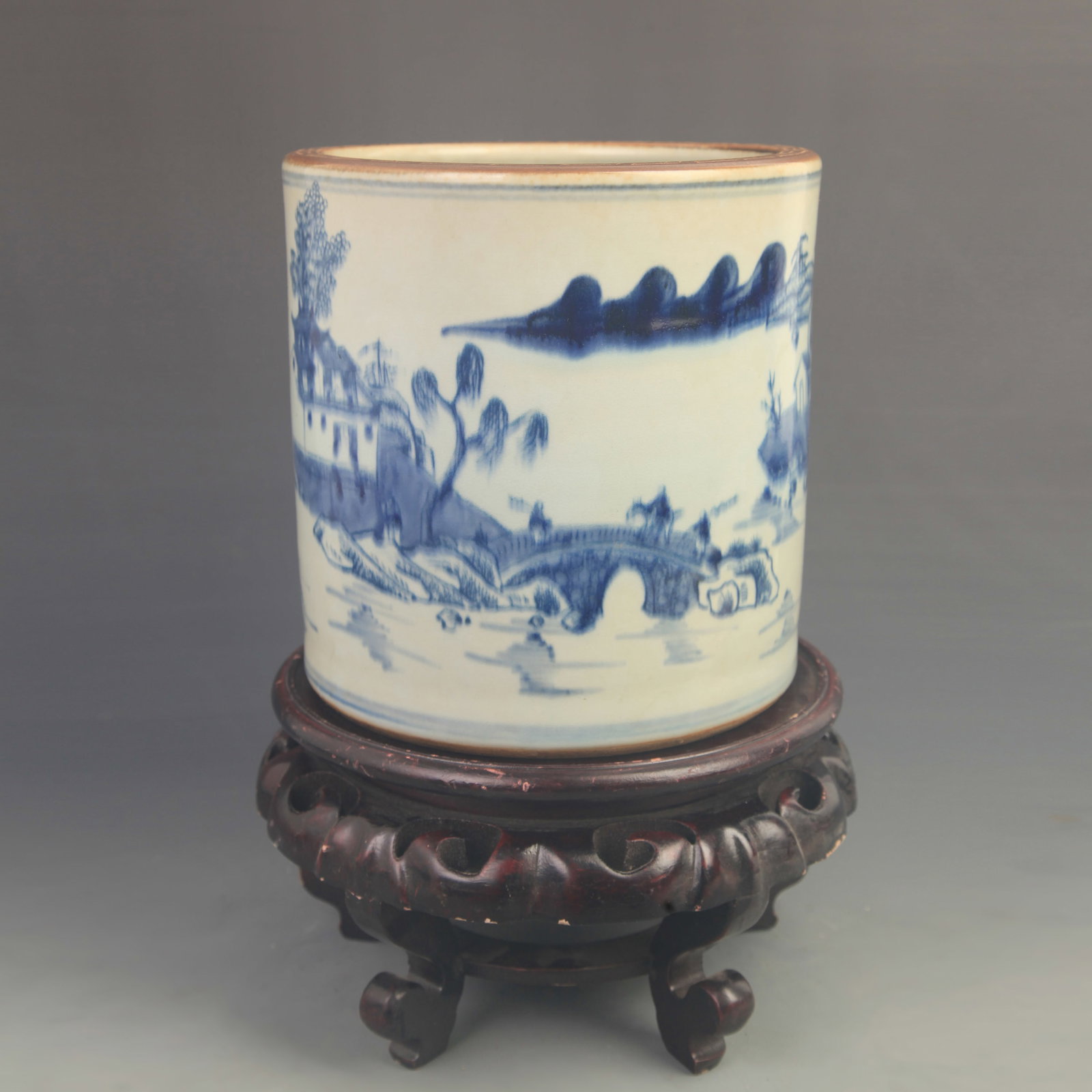 BLUE AND WHITE LANDSCAPE AND FIGURE PORCELAIN BRUSH POT: Qing Dynasty Kang Xi Period; High: 8.20 inch; Diameter: 8.00 inch; Woodbase for picture and display only