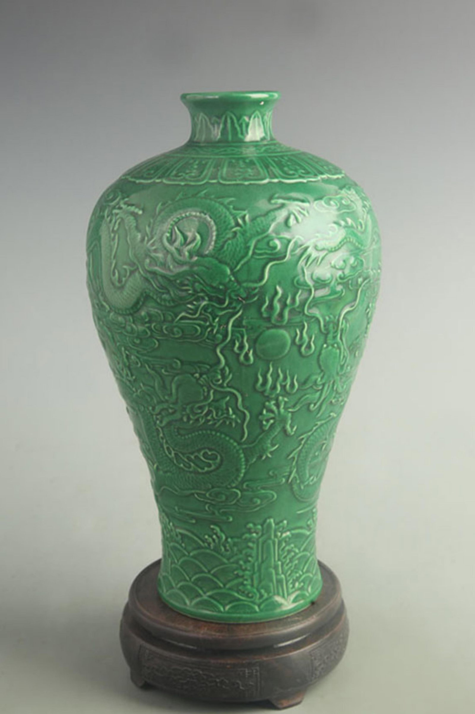 GREEN-GROUND CARVED MEIPING PORCELAIN VASE WITH DRAGON MOTIF: Qing Dynasty Qian Long Period; High: 12.0 inch; Width: 6.00 inch; Woodbase for picture and display only