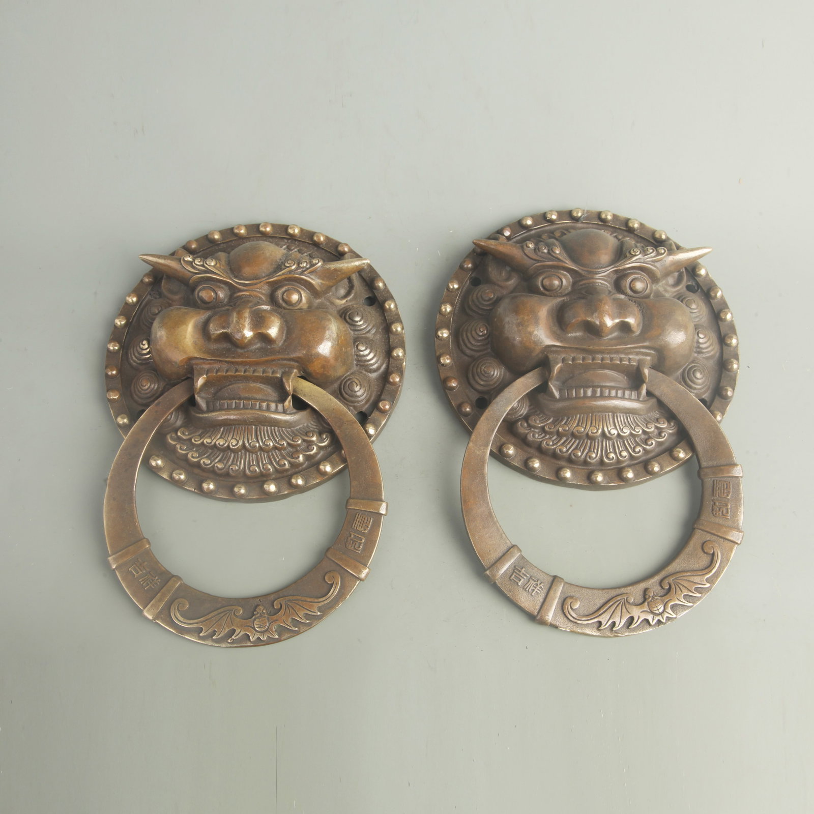 PAIR OF CHINESE BRASS OR BRONZE LION-HEAD DOOR KNOCKERS: Qing Dynasty;Long:7.50 inch; Woodbase for picture and display only