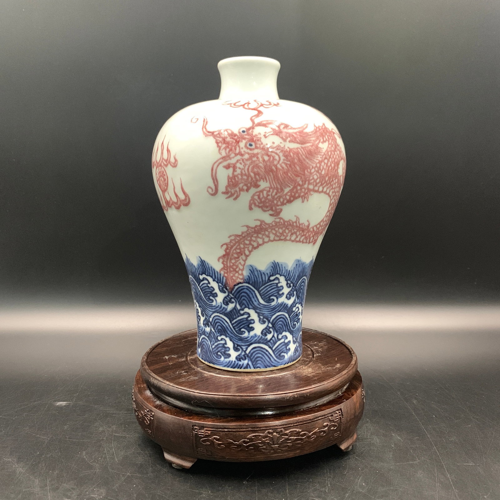 UNDERGLAZE BLUE AND COPPER RED "SEA DRAGON" MEIPING VASE: Qing Dynasty; High: 8.1 inch; Diameter: 5.3 inch; Woodbase for picture and display only