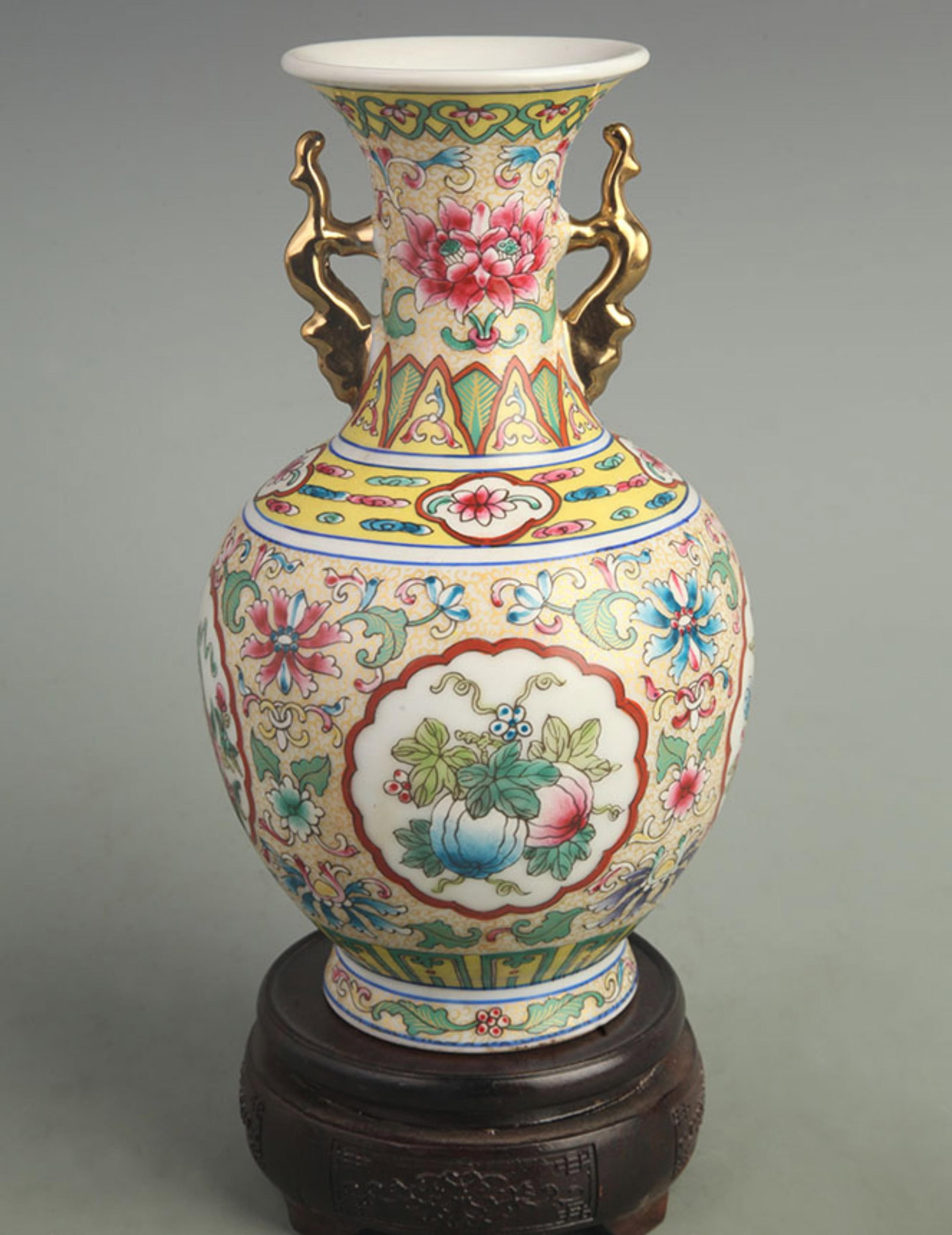 A FINE ENAMEL COLOR DOUBLE HANDLED FLORAL PORCELAIN VASE: Qing Dynasty Qian Long Period; High: 9.00 inch; Width: 5.00 inch; Woodbase for picture and display only