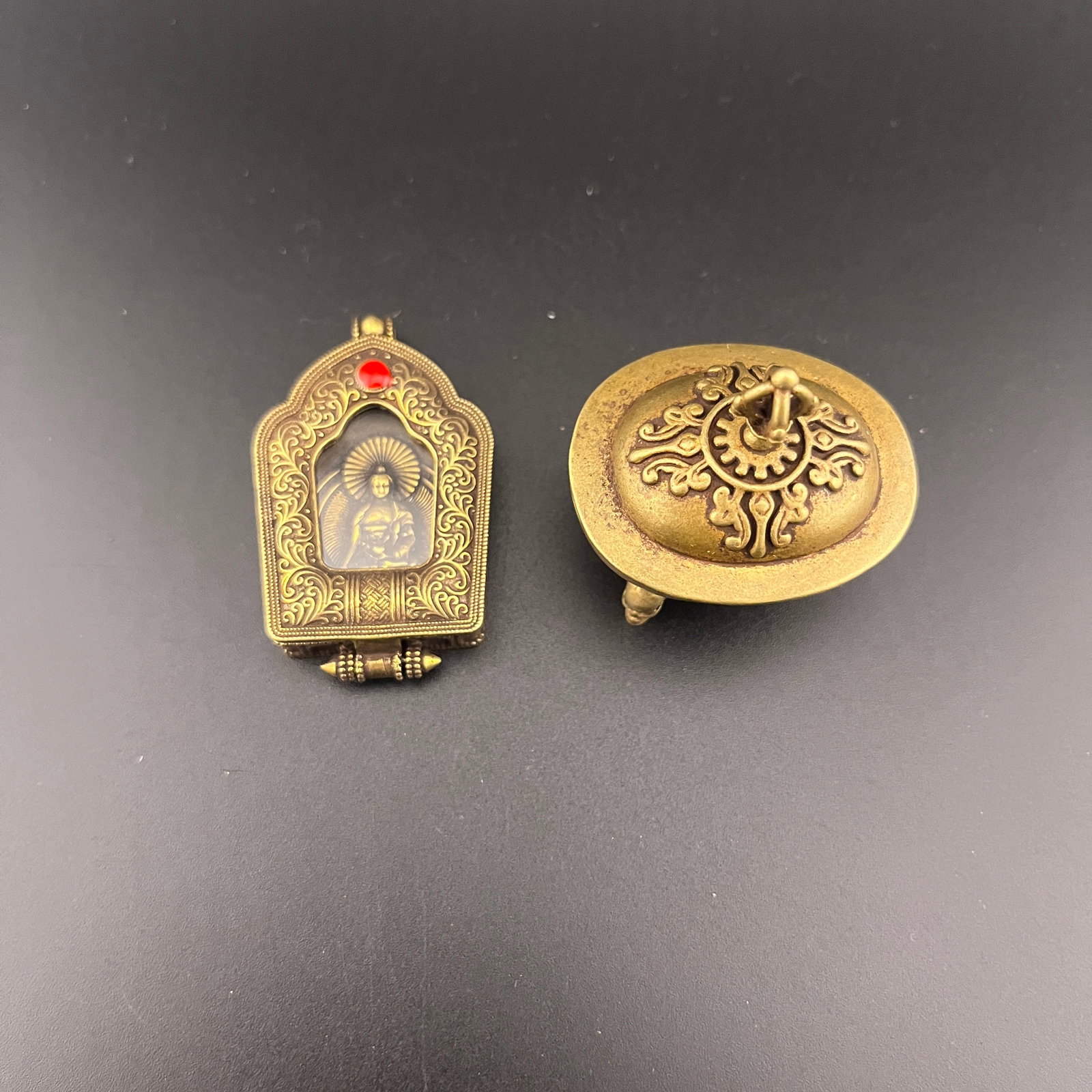 GROUP OF TWO TIBETAN PENDANTS SIPAHO PLAQUES: 20th Century; Long: 1.7 inch; Width: 1.3 inch; High: 1.9 inch; Long: 2.12 inch; Width: 1.28 inch; High: 0.4 inch; Woodbase for picture and display only