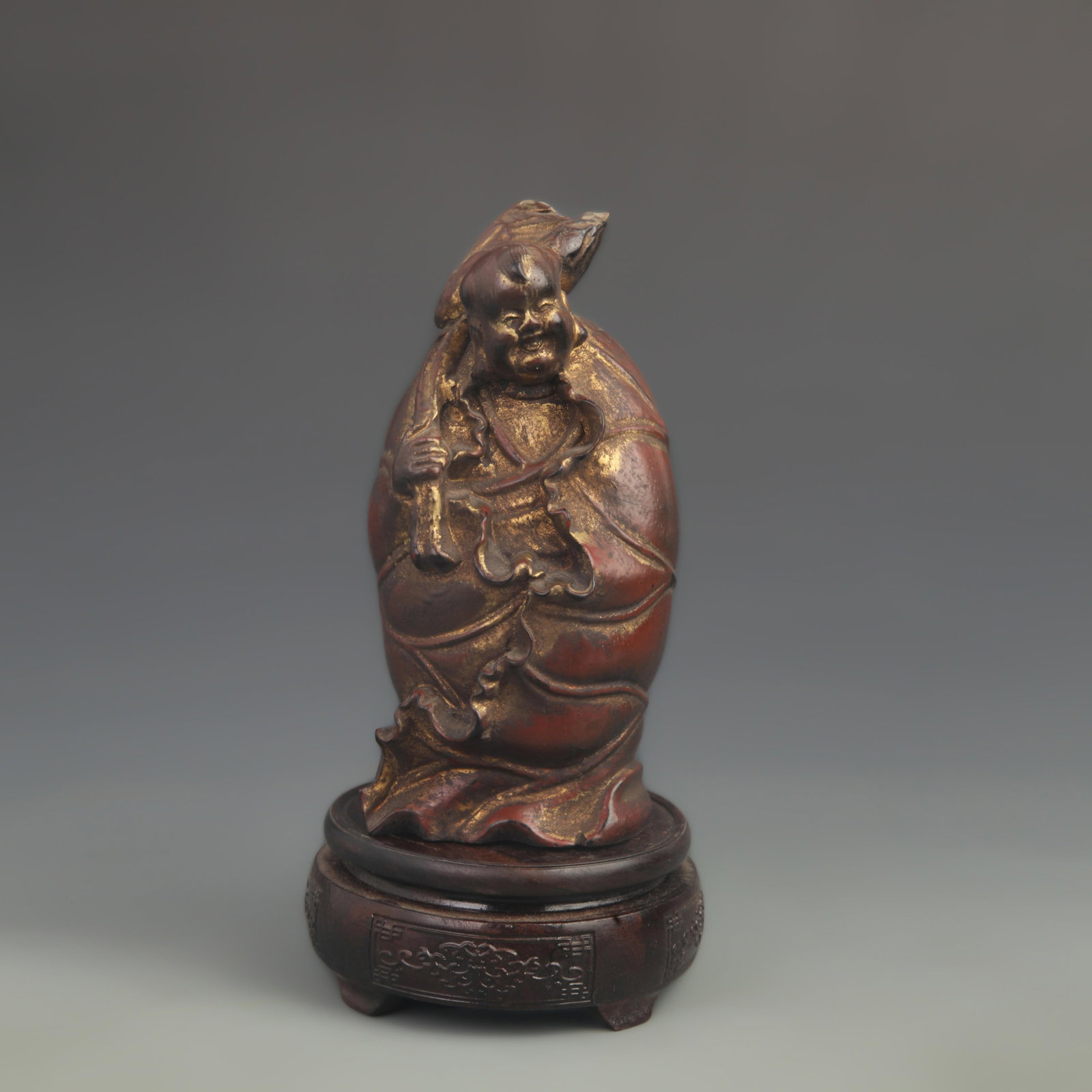GILT-LACQUER WOODEN FIGURE OF BOY HOLDING LOTUS LEAF: 20th Century; High: 7.25 inch; Width: 3.50 inch; Woodbase for picture and display only