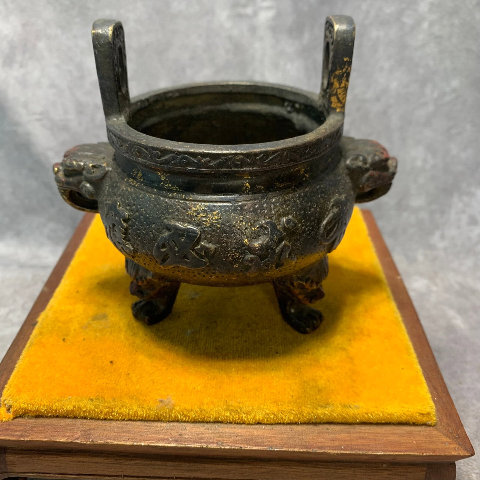 QIAN LONG MARKED GILDED BRONZE INCENSE BURNER WITH LION EARS: Qing Dynasty; High: 4.4 inch Diameter: 4.9 inch. Wooden base for display only