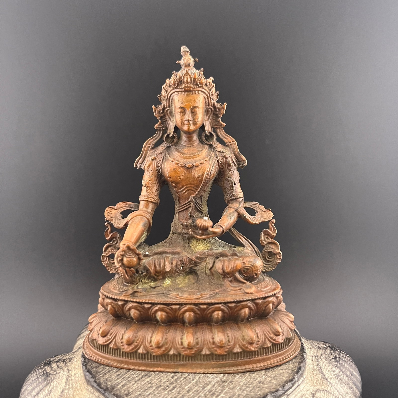 TIBETAN COPPER-BRONZE STATUE OF SEATED TARA: Qing Dynasty; Long: 2.8 inch; Width: 1.8 inch; High: 3.8 inch; . Wooden base for display only