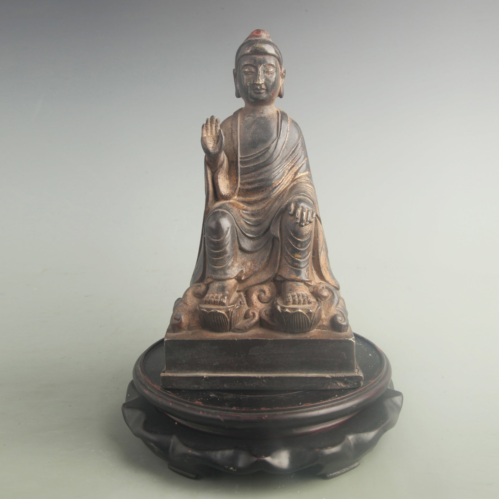 A GILT BRONZE SAKYAMUNI BUDDHA FIGURE: 20th Century; High: 9.20 inch; Width: 4.80 inch. Wooden base for display only