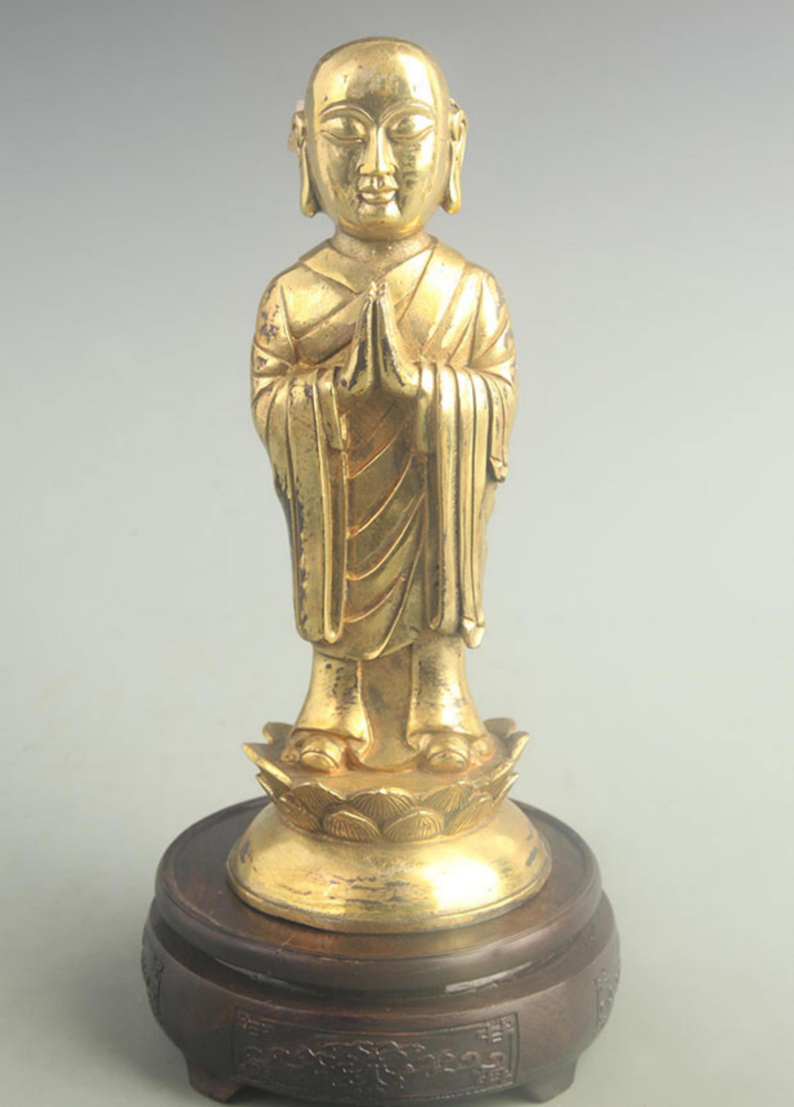 A FINE GILT BRONZE TIBETAN BUDDHA STATUE ANANDA: 20th Century; High: 9.50 inch; Diameter: 3.80 inch; . Wooden base for display only