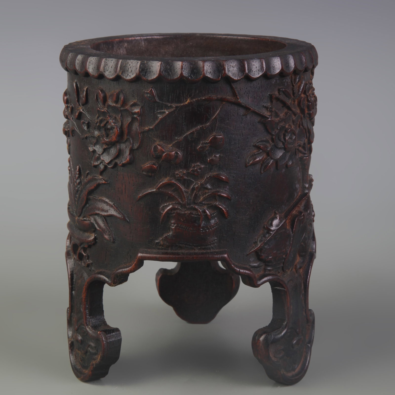 A FINE CARVED SANDALWOOD TRIPOT BRUSH POT: Qing Dynasty; Diameter: 4.4 inch; High: 5.7 inch. Wooden base for display only