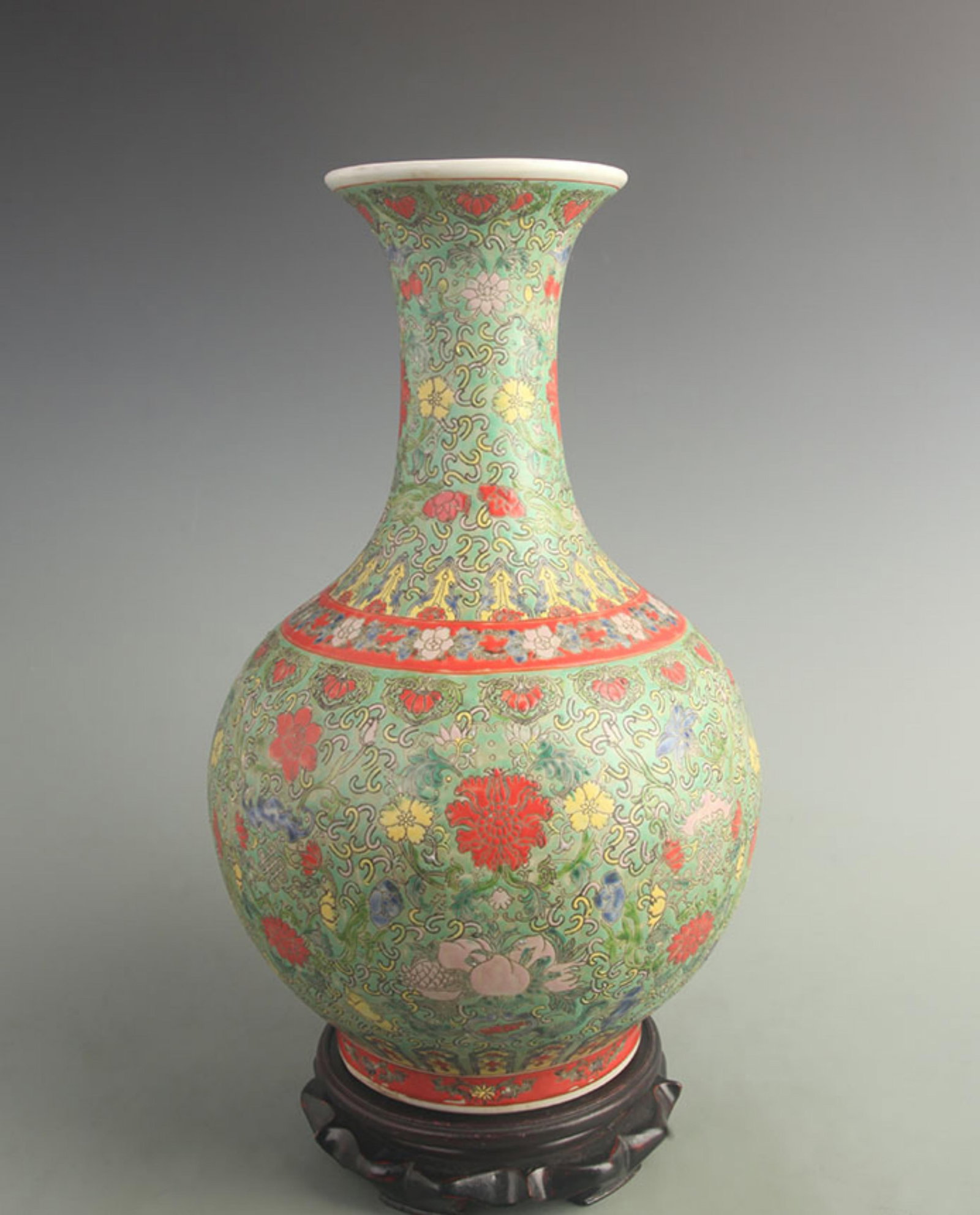 GREEN-GROUND FAMILLE ROSE FLORAL APPRECIATION VASE: Qing Dynasty Qian Long Period; High: 15.5inch; W: 9.50inch. Wooden base for display only