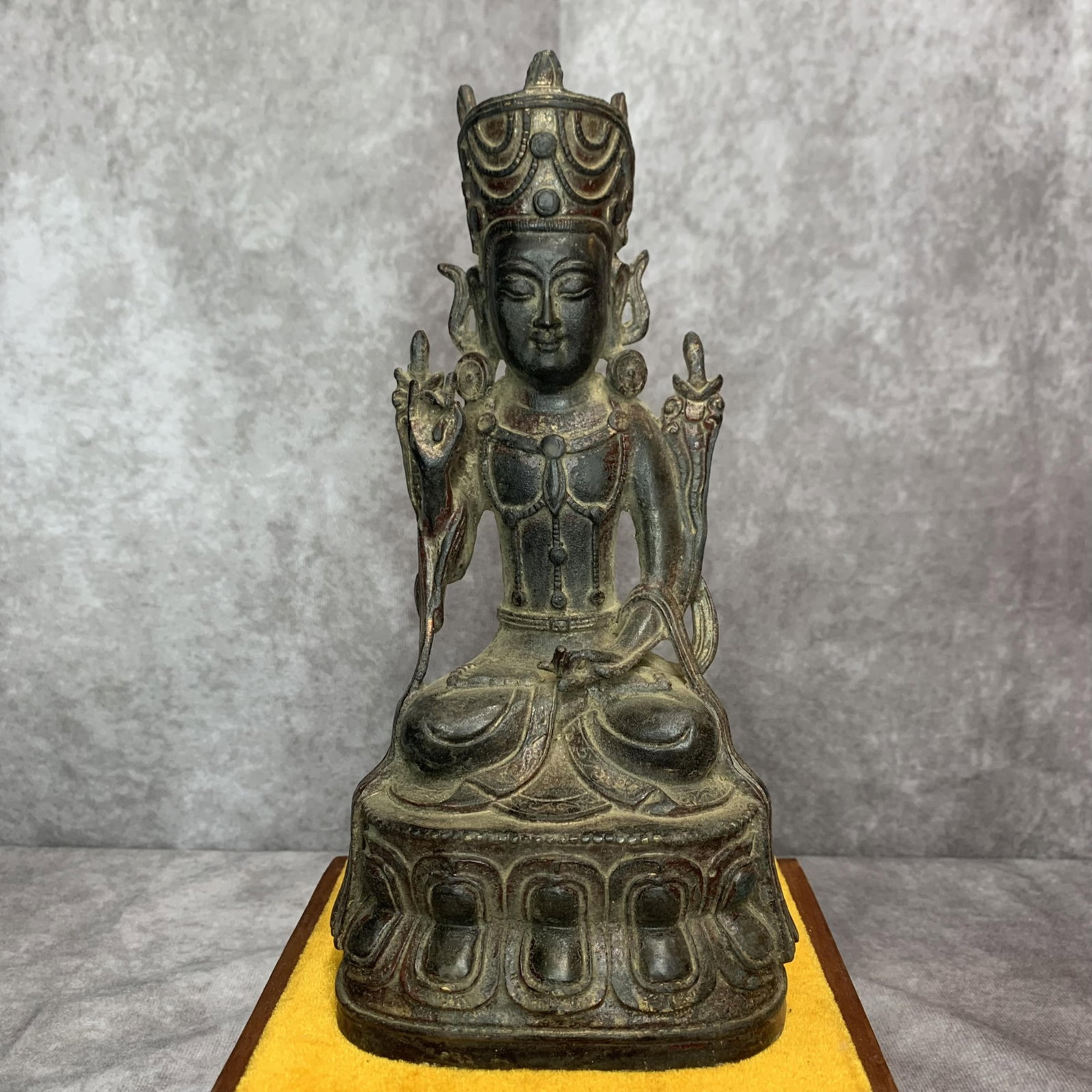 A FINELY CAST BRONZE BUDDHA STATUE: 19th Century; High: 9.5 inch; Width: 3.6 inch; Long: 4.5 inch. Wooden base for display only