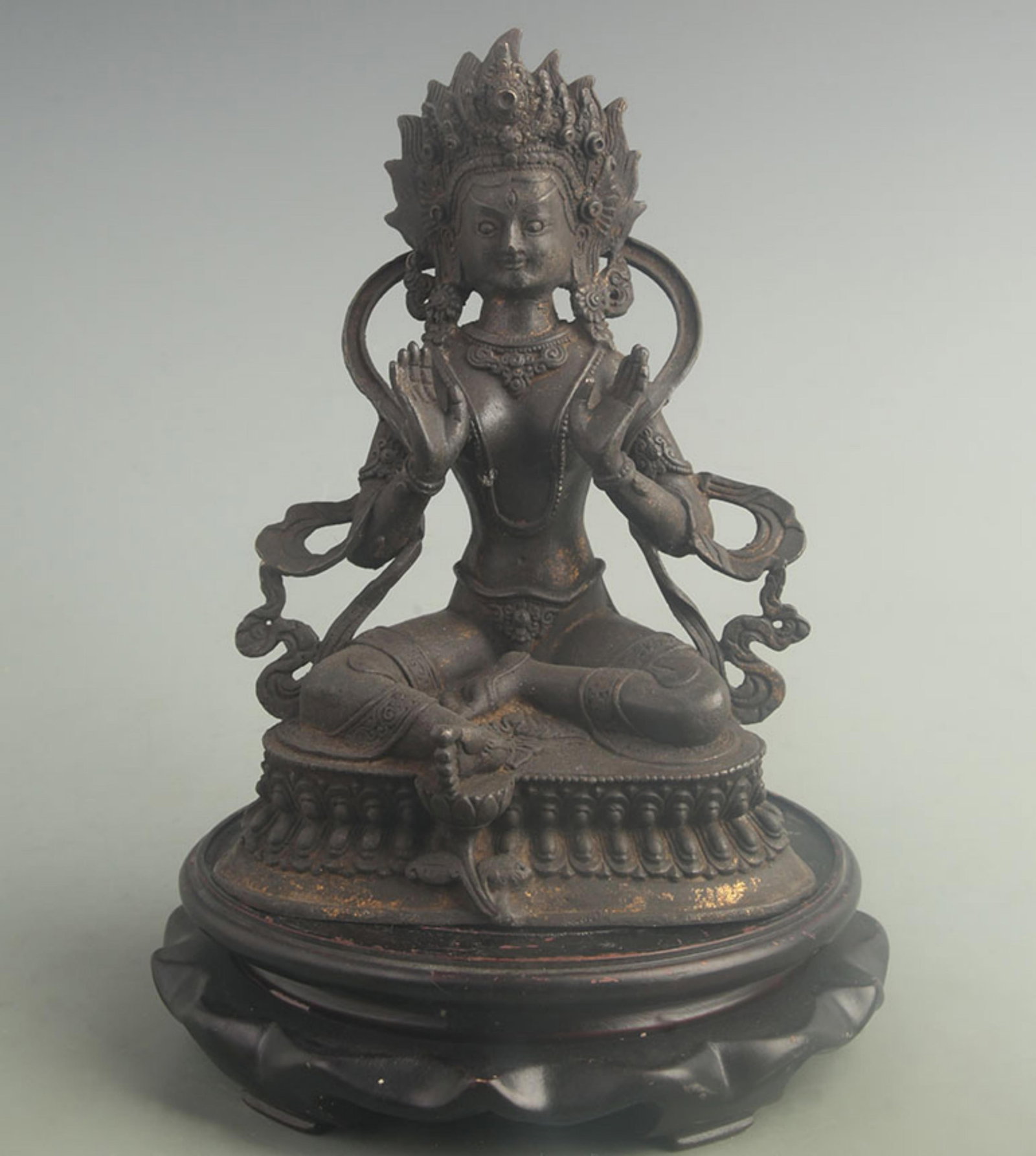 TIBETAN-STYLE BRONZE STATUE OF THE DEITY TARA: 19th Century; High: 8.80 inch; Width: 4.00 inch; Long: 6.10 inch; . Wooden base for display only