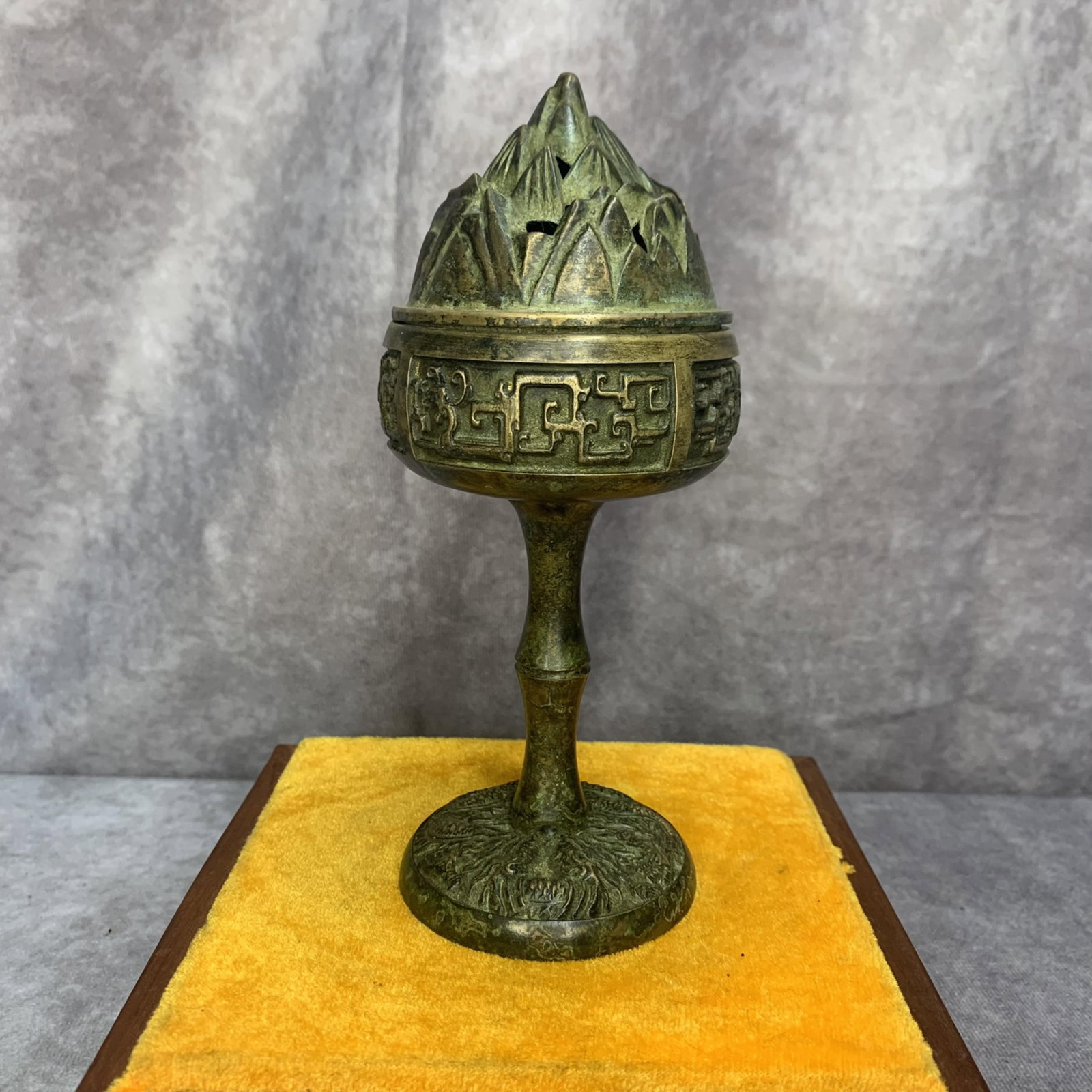 A FINELY CARVED TALL FOOT BRONZE CENSER: 20th Century; High: 7.0 inch; Diameter: 3.0 inch. Wooden base for display only