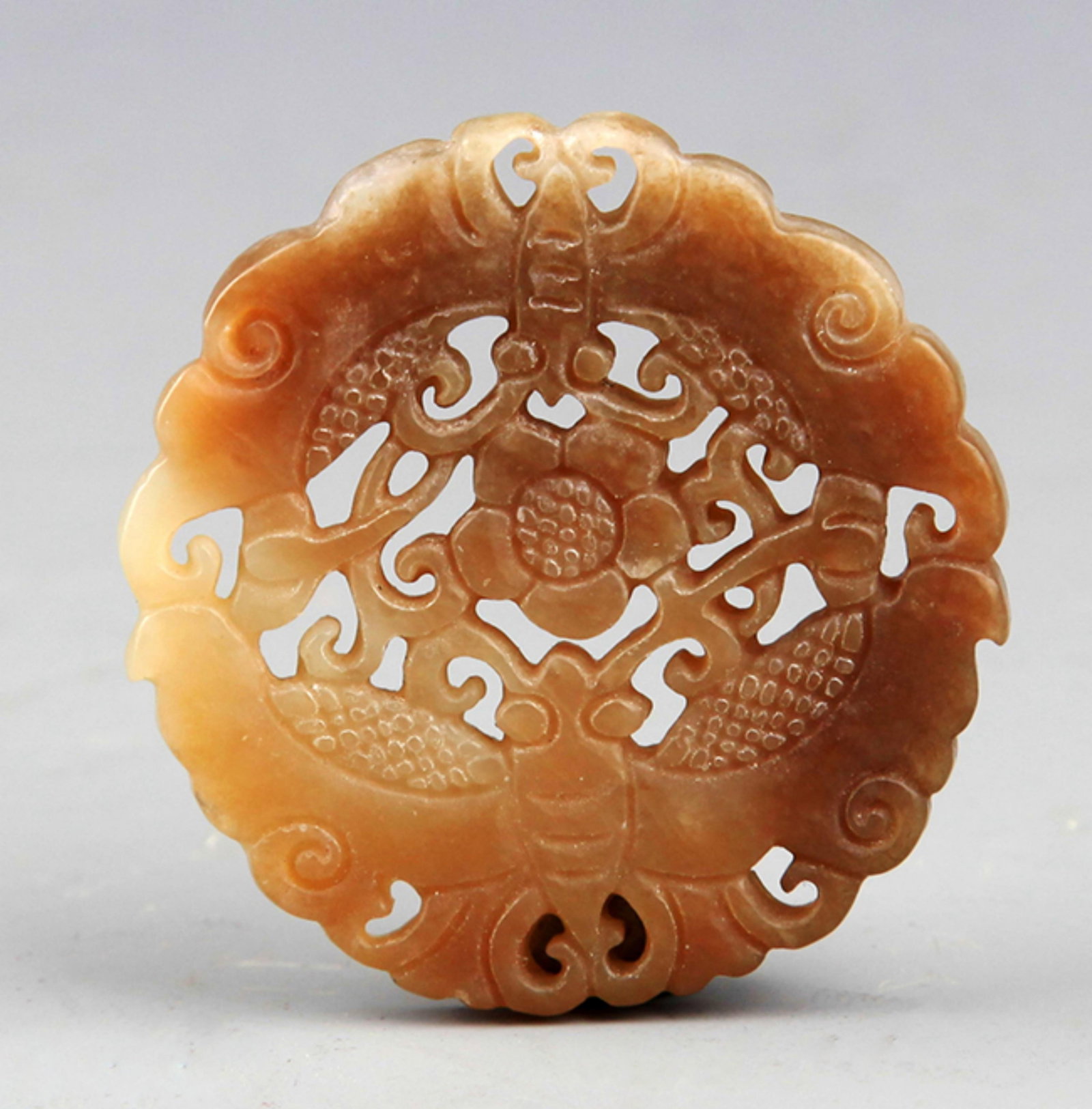 A FINE YELLOW HOLLOW CARVING BUTTERFLY FIGURE JADE: 20th Century; Diameter: 1.75 inch; . Wooden base for display only