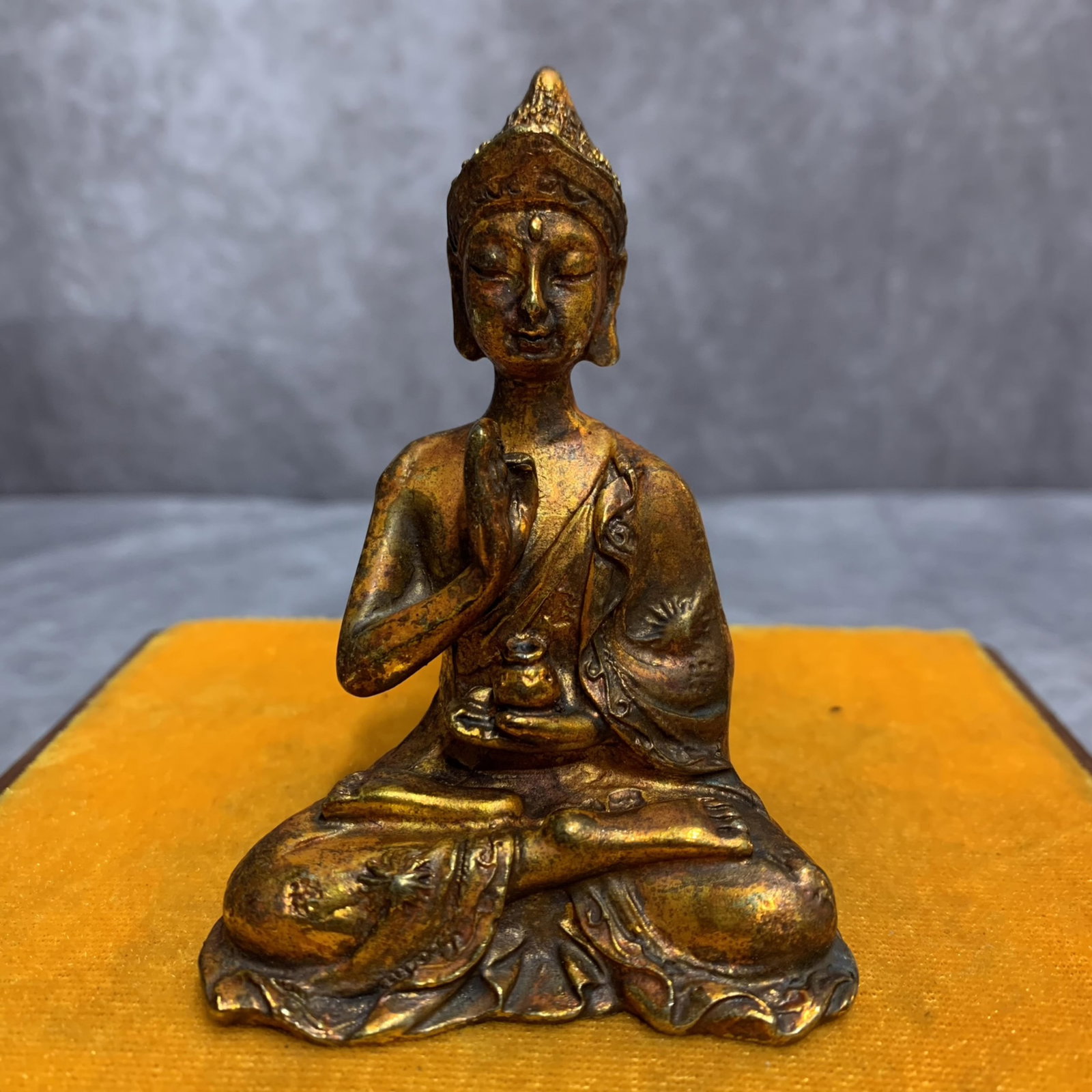 A SMALL TIBETAN BRONZE BUDDHA STATUE: 20th Century; Width: 2.4 inch; High: 3.5 inch; . Wooden base for display only