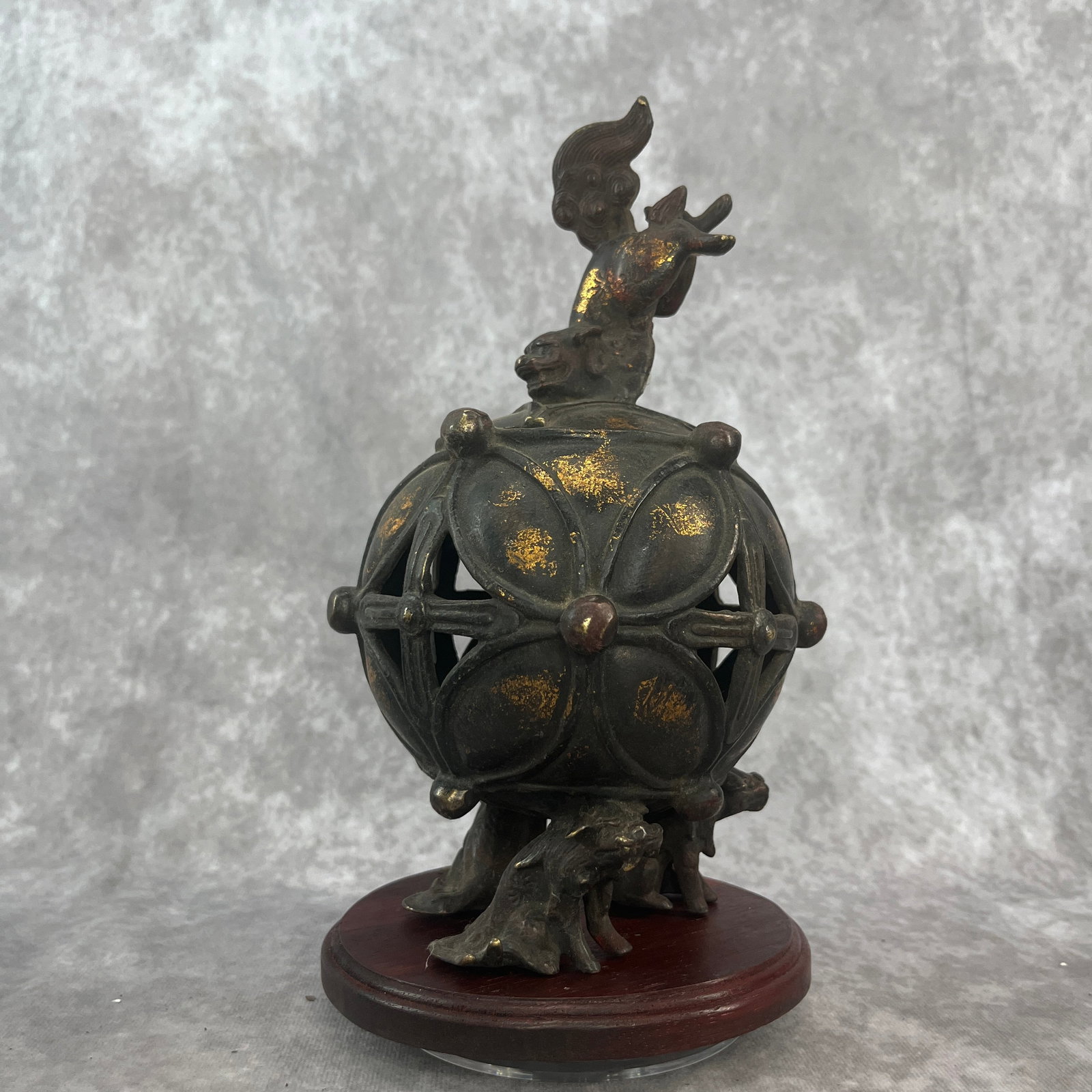 A FINE BRONZE LION PLAYING EMBROIDERY BALL FIGURE INCENSE BURNER: 19th Century; High: 8.9 inch; Diameter: 5.5 inch; . Wooden base for display only