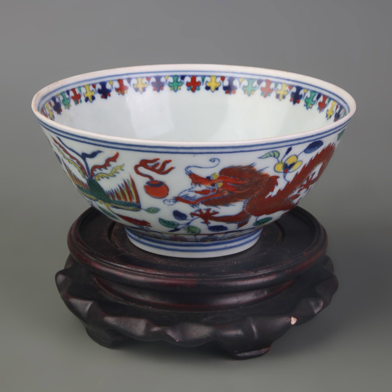 DOUCAI DRAGON AND PHOENIX PATTERN PORCELAIN BOWL: Qing Dynasty Yong Zheng Period; Diameter: 5.6 inch; High: 2.5 in. Wooden base for display only
