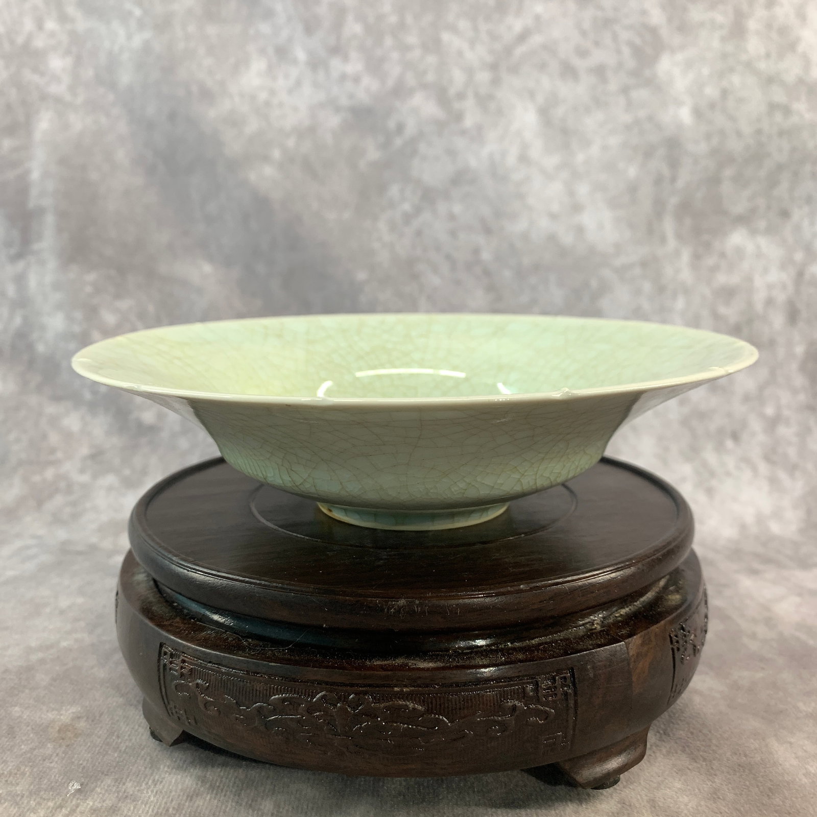 LONGQUAN-STYLE CELADON CRACKLE BASIN WITH TWIN FISH RELIEF: Yuan Dynasty Style; High: 1.8 inch; Diameter: 6.9 inch; . Wooden base for display only